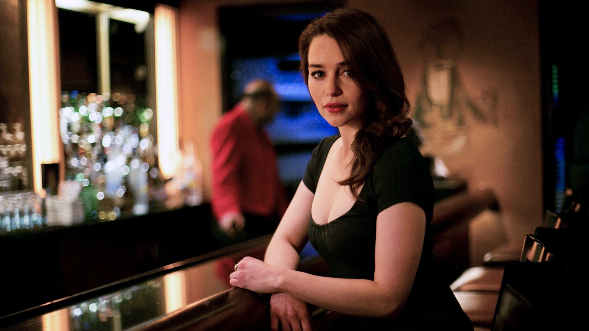 Emilia Clarke in a black dress at a bar HD Wallpaper