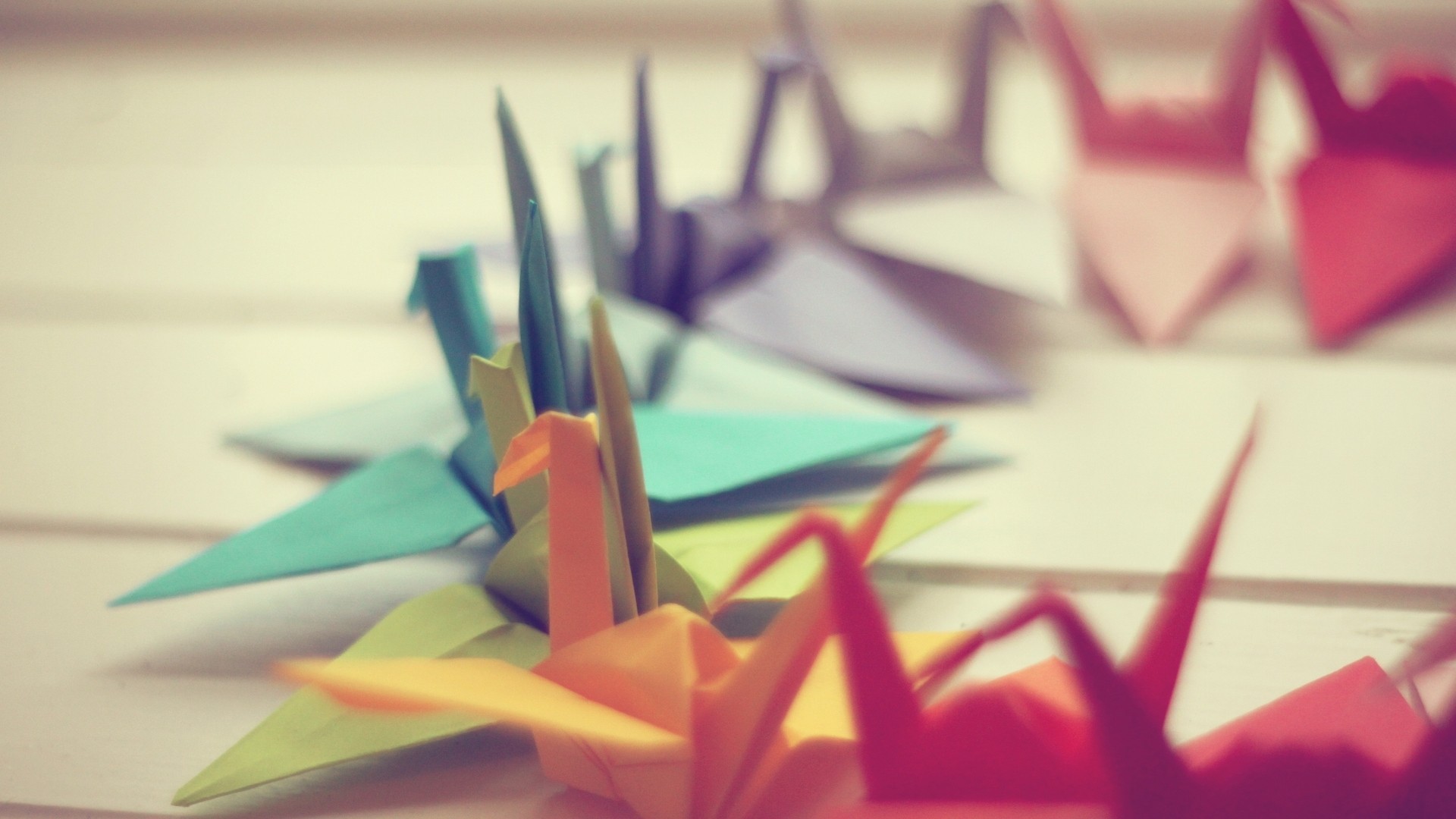 Colorful origami paper cranes arranged in a row HD Wallpaper
