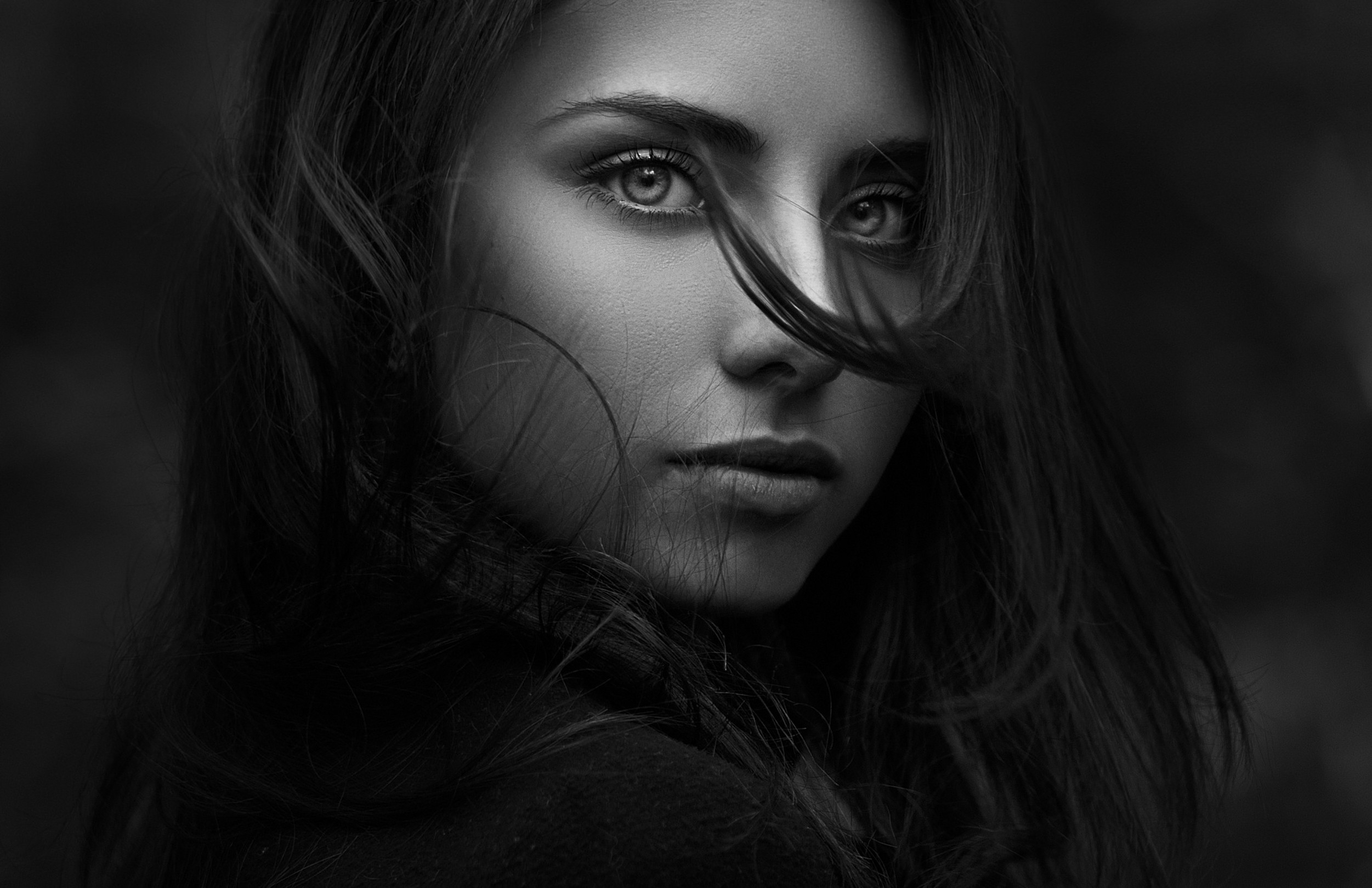 Monochrome portrait of a woman with hair in her face HD Wallpaper