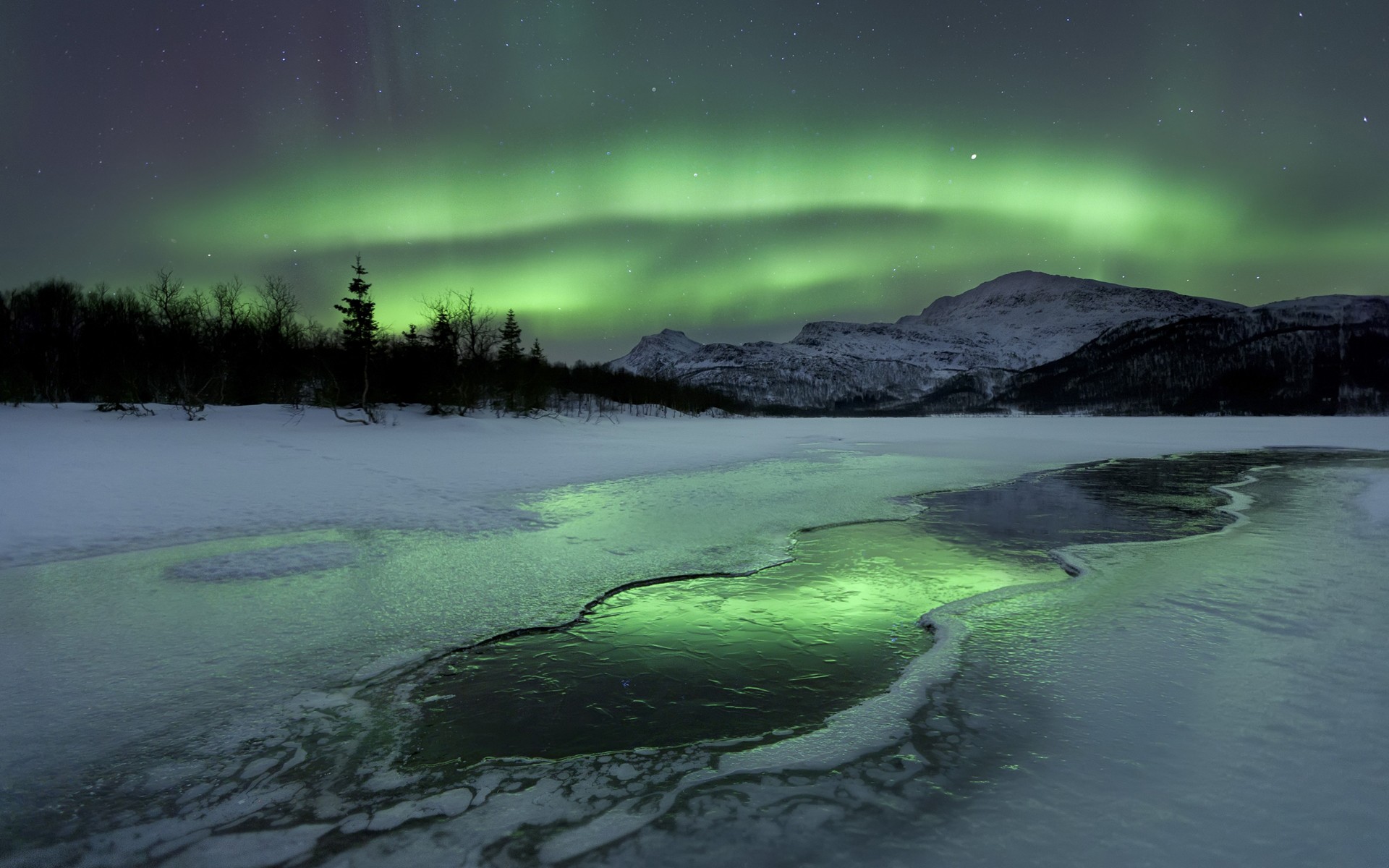Aurora Borealis over a frozen landscape HD Wallpaper