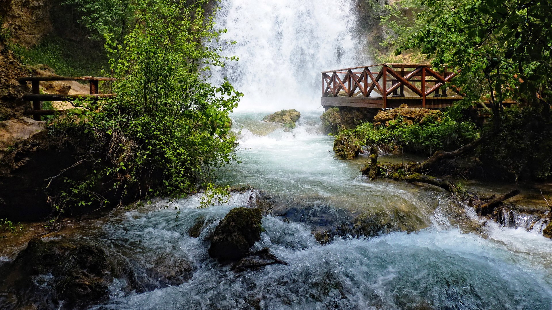 Waterfall with wooden viewing platform and railing HD Wallpaper