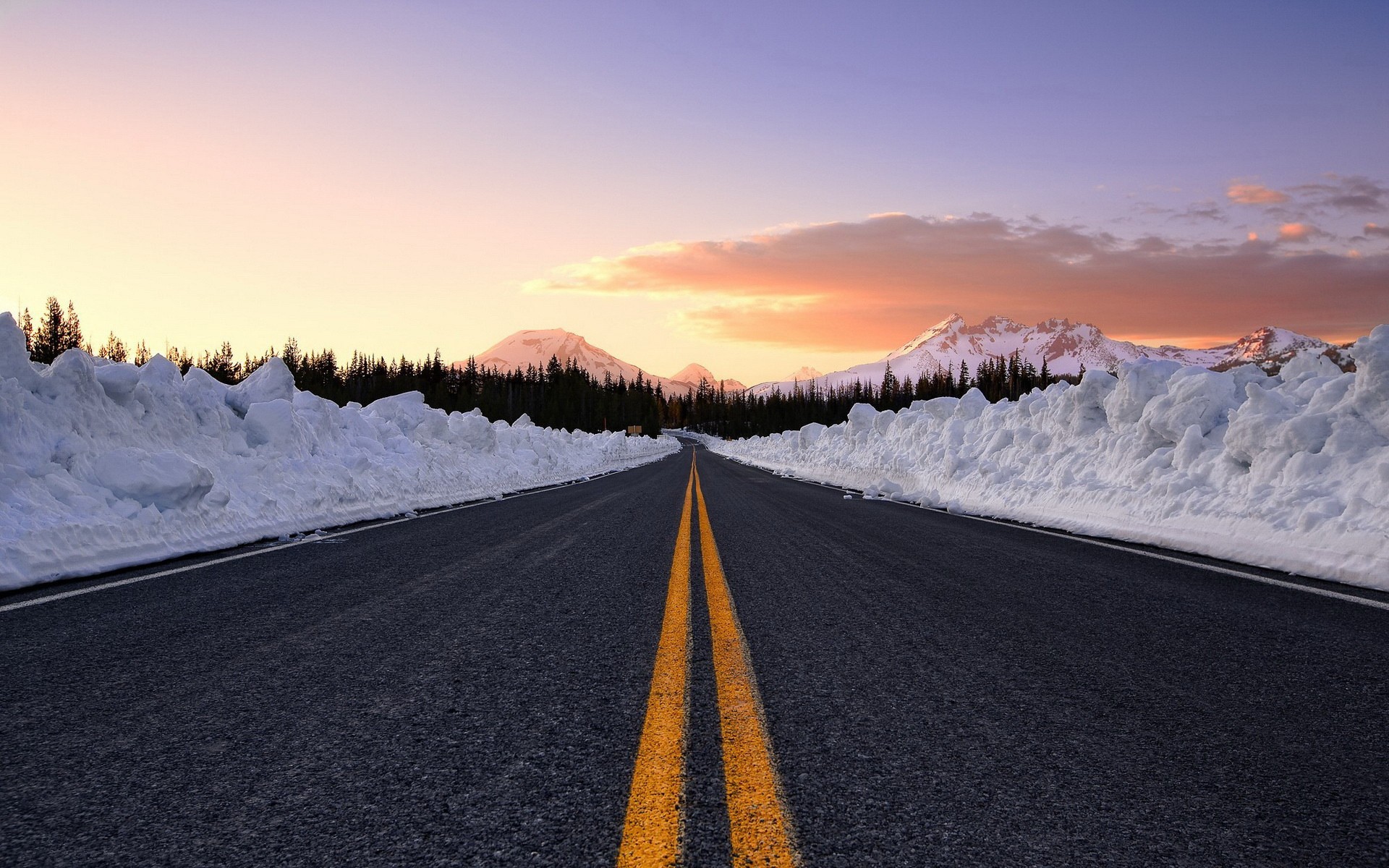 Snowy mountain road at sunset HD Wallpaper
