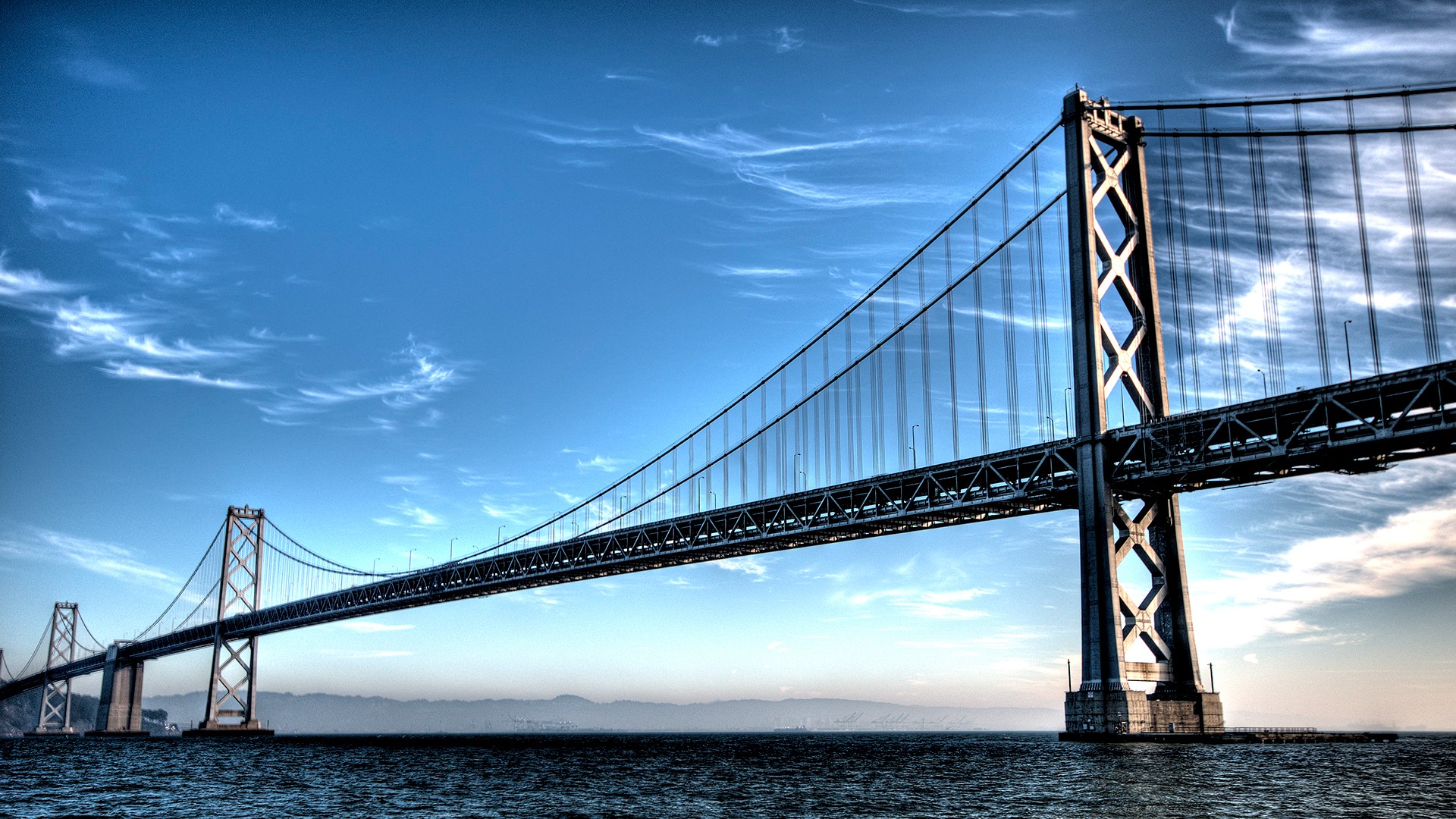 San Francisco-Oakland Bay Bridge under a blue sky HD Wallpaper