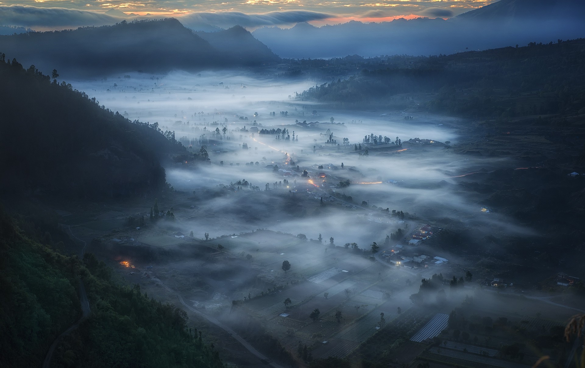 Misty valley with villages at sunrise in Indonesia HD Wallpaper