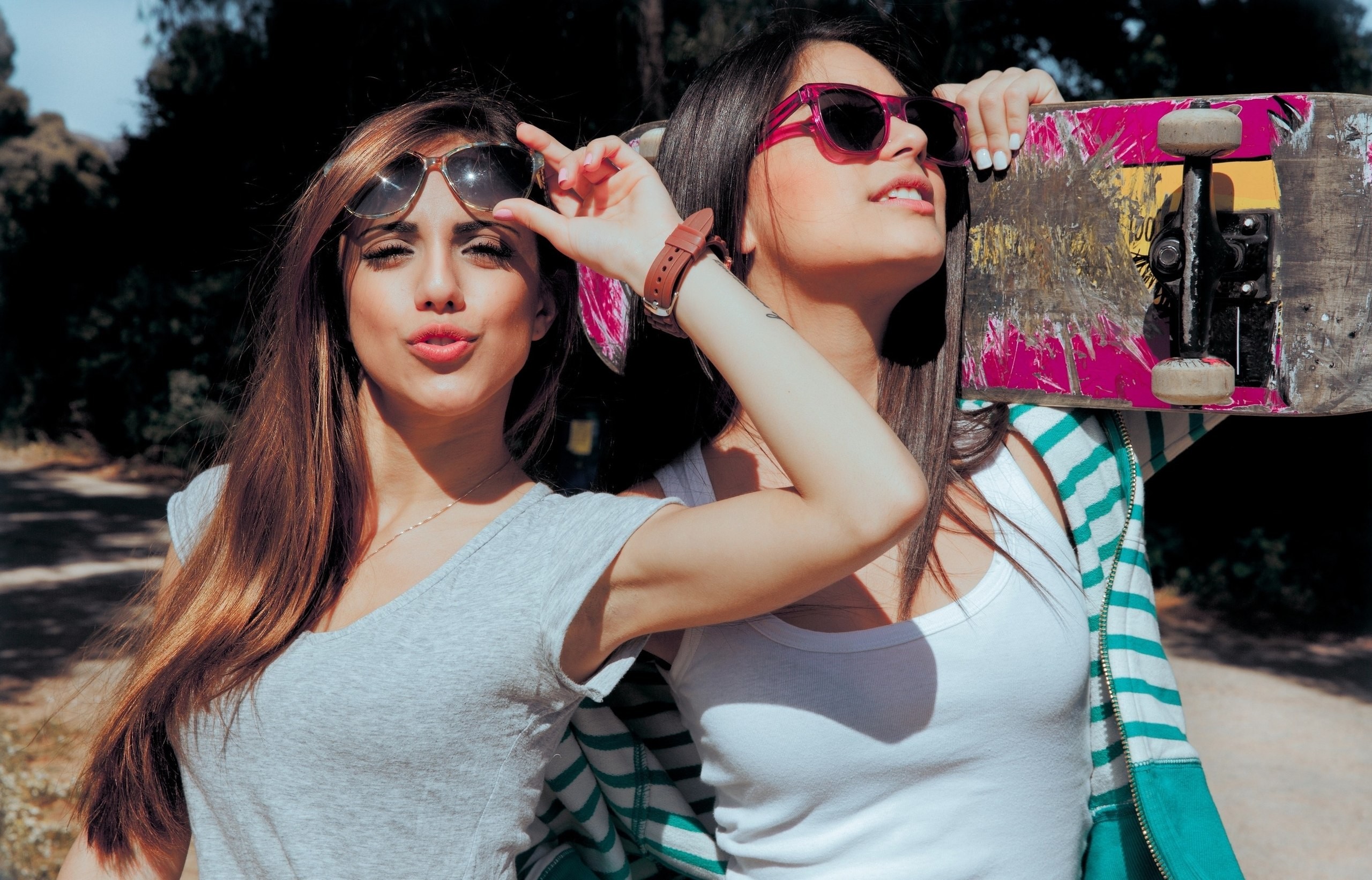 Two women with sunglasses and a skateboard HD Wallpaper