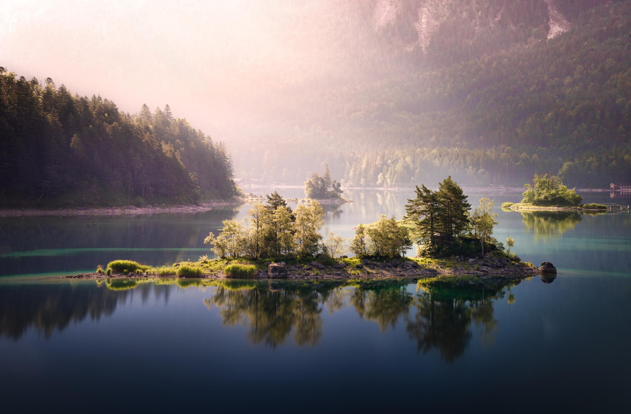 Islands in a misty lake surrounded by forests HD Wallpaper