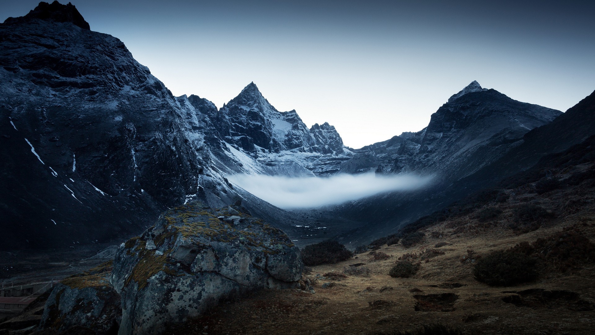 Misty mountains under a dark sky HD Wallpaper