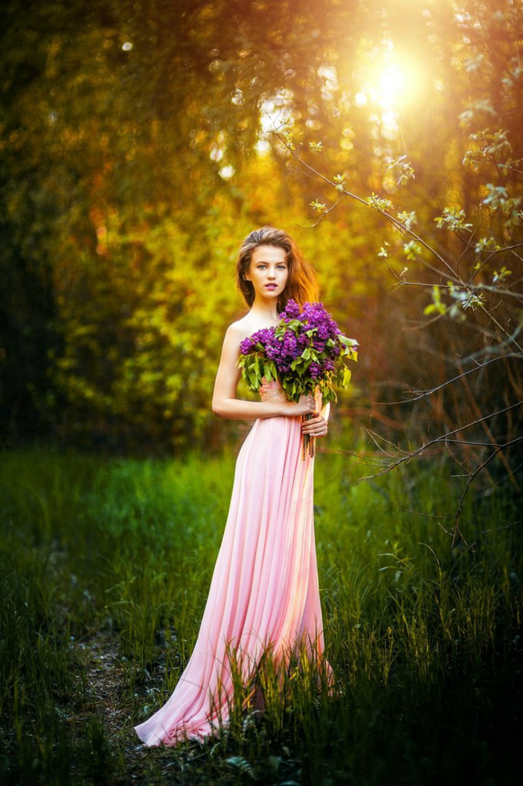 Woman in pink dress holding lilac flowers outdoors HD Wallpaper
