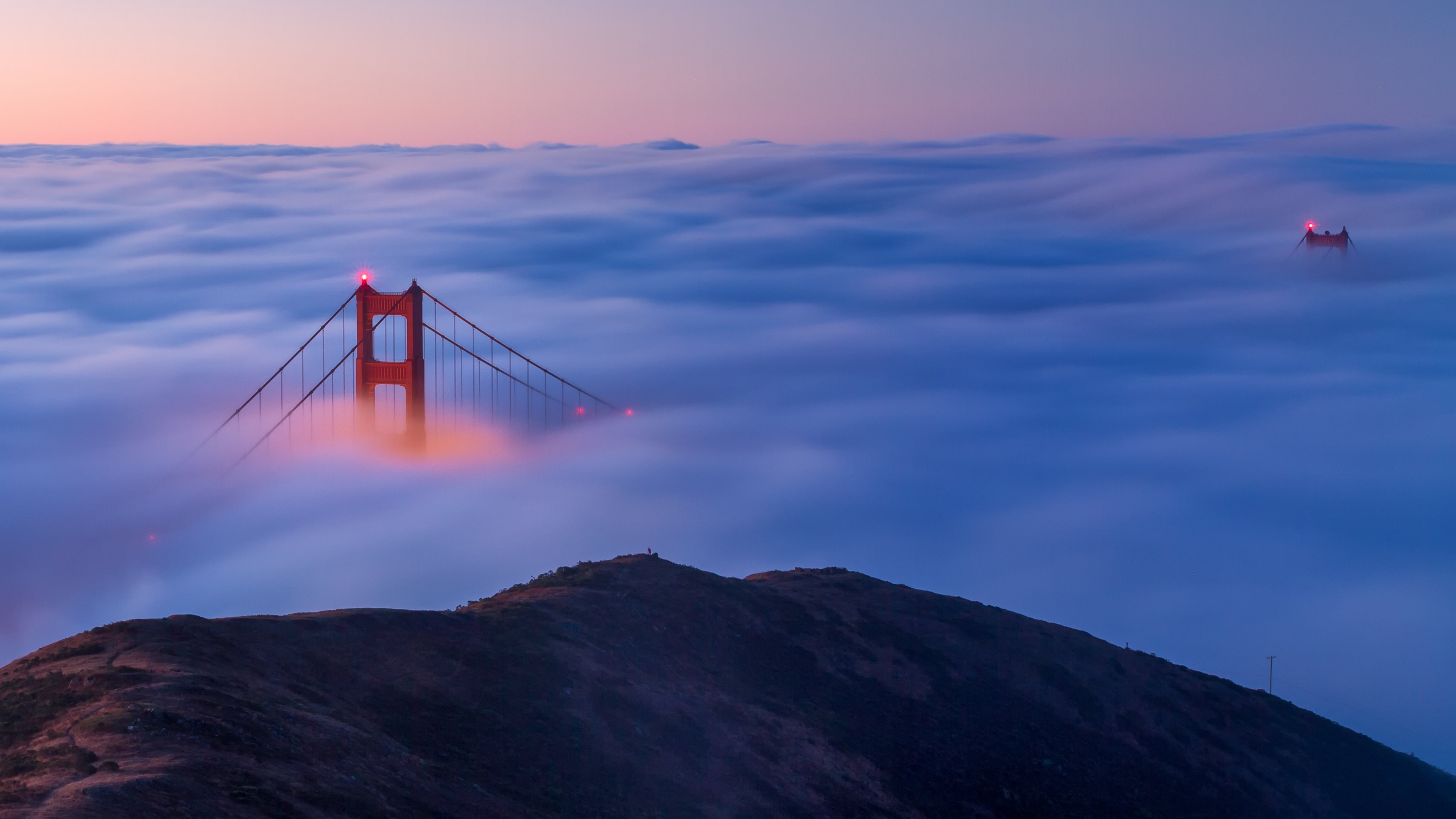 Golden Gate Bridge emerges from fog at sunrise HD Wallpaper