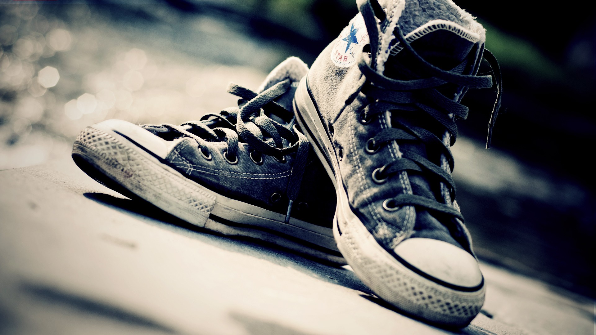 Converse shoes on a textured surface HD Wallpaper