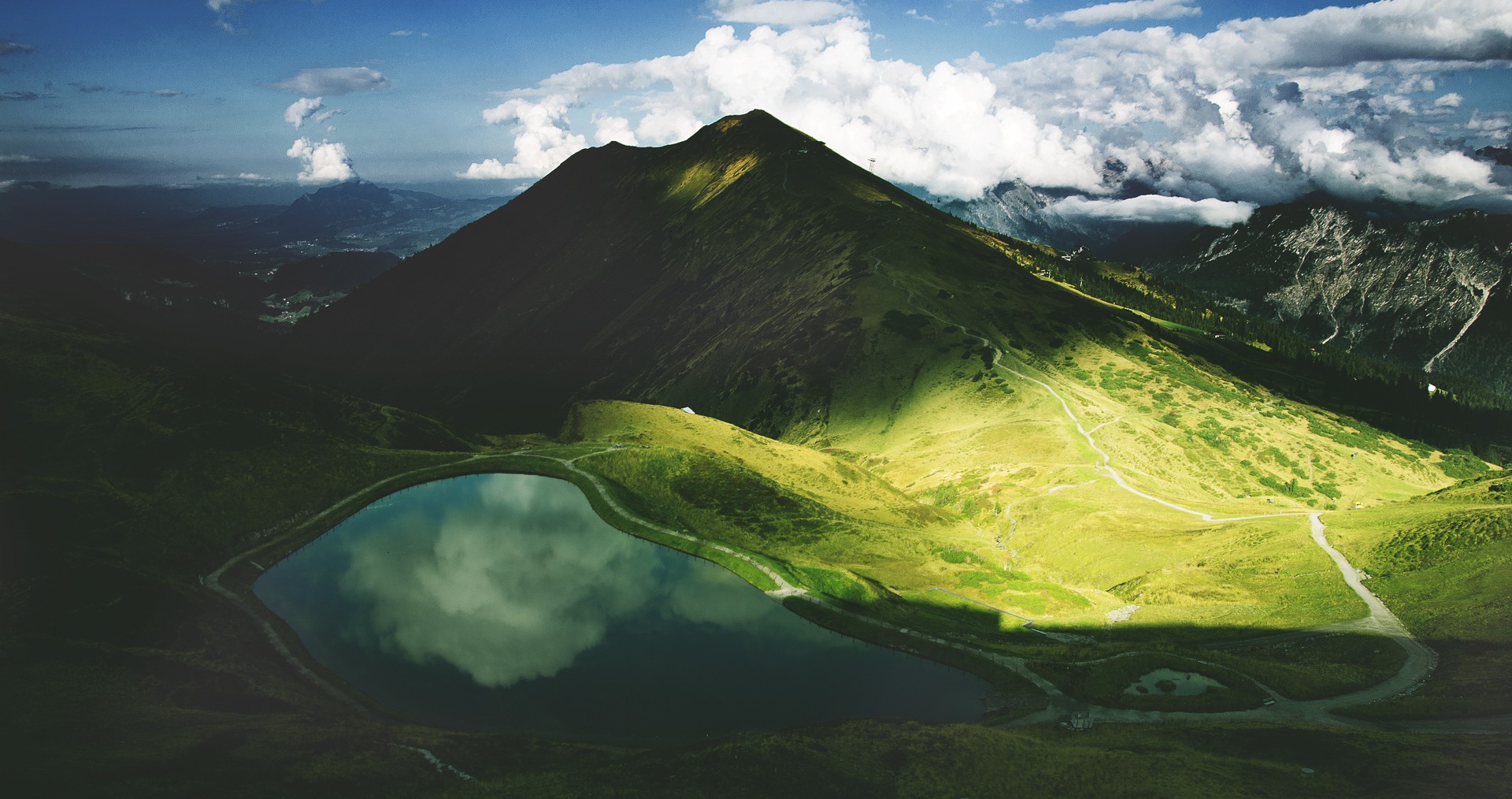 Mountain lake reflecting clouds and sky HD Wallpaper