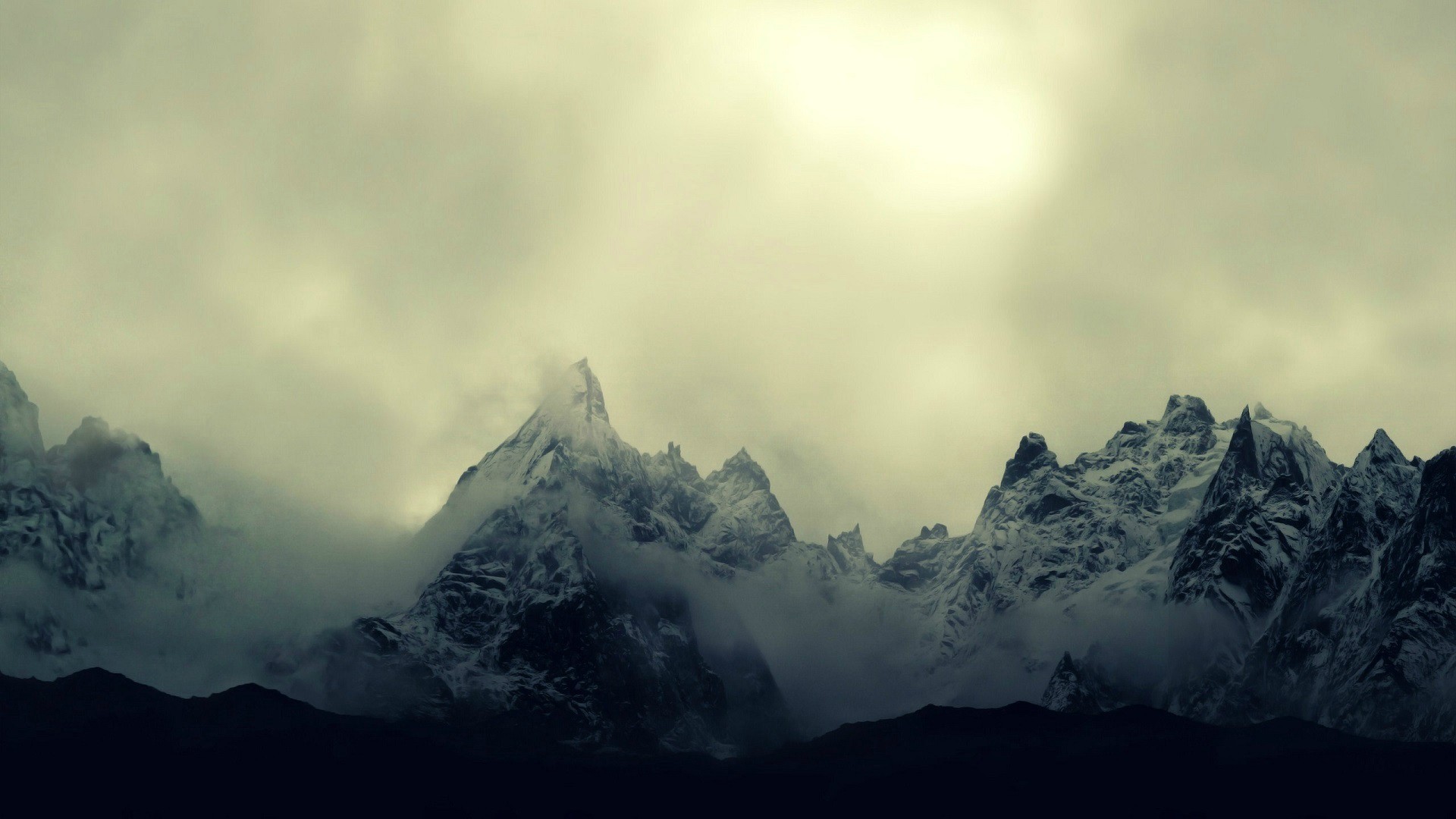 Snow-covered mountains shrouded in mist HD Wallpaper