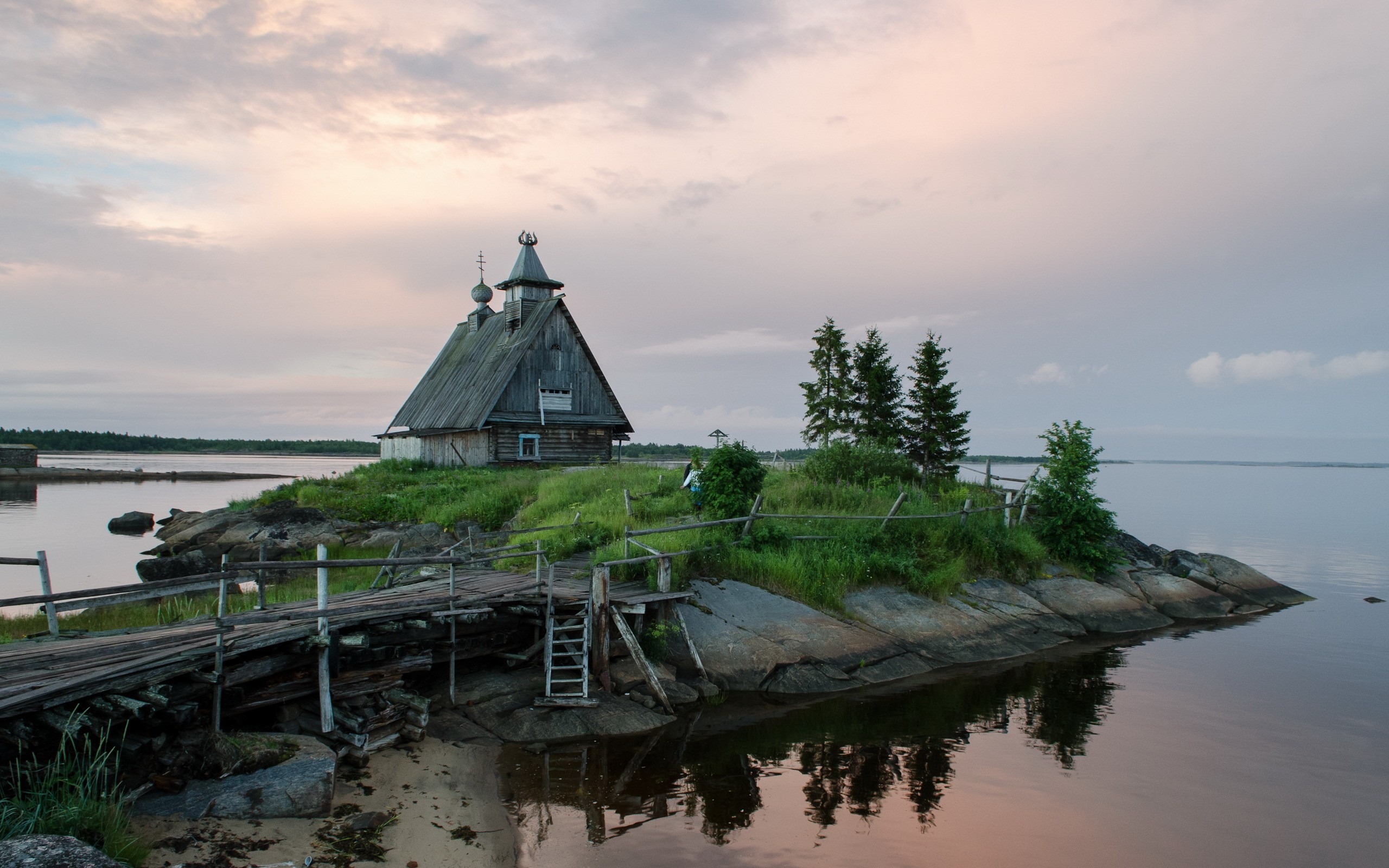 Wooden church on a rocky island with a wooden bridge HD Wallpaper
