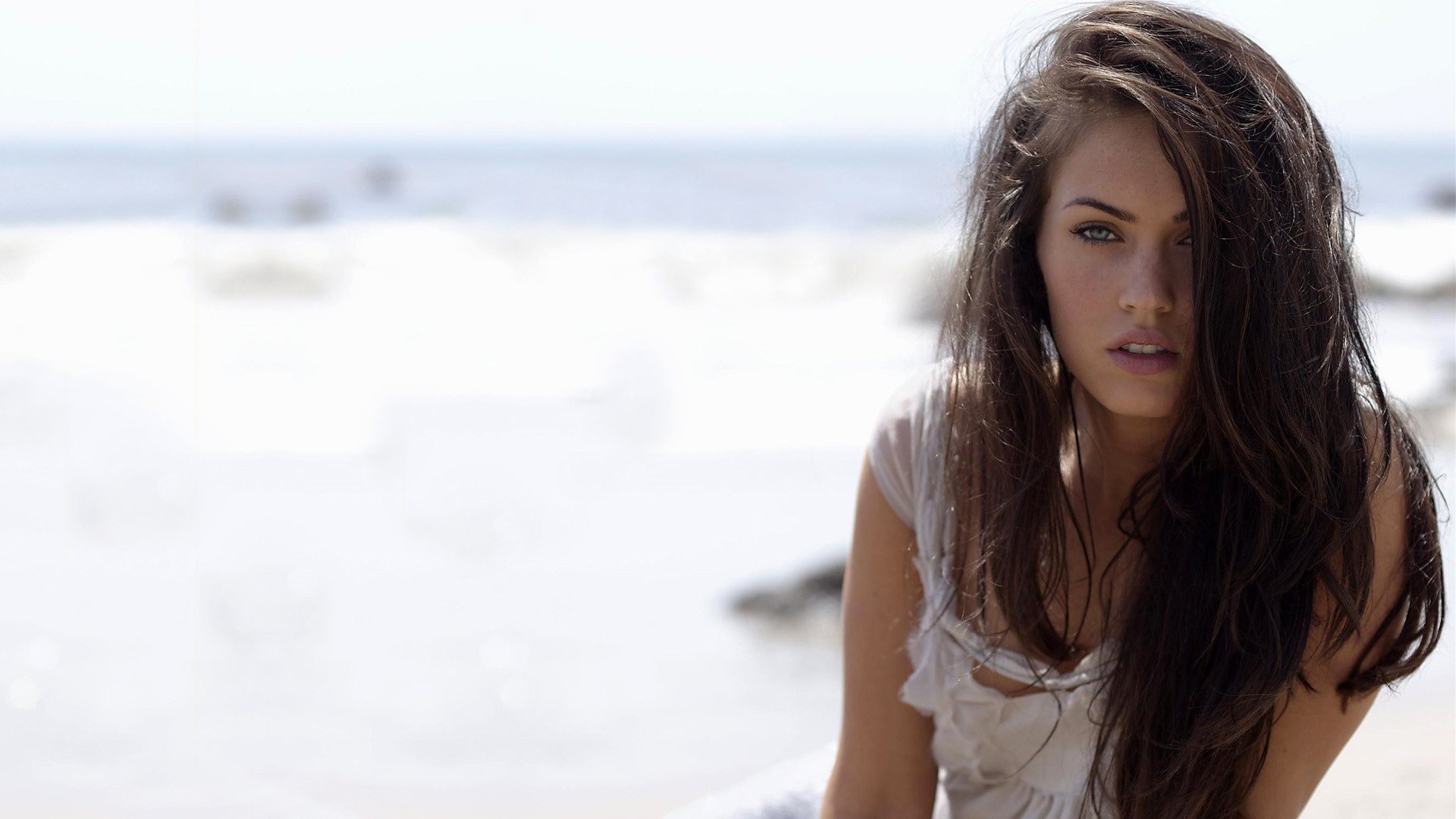 Megan Fox on a beach with ocean in the background HD Wallpaper