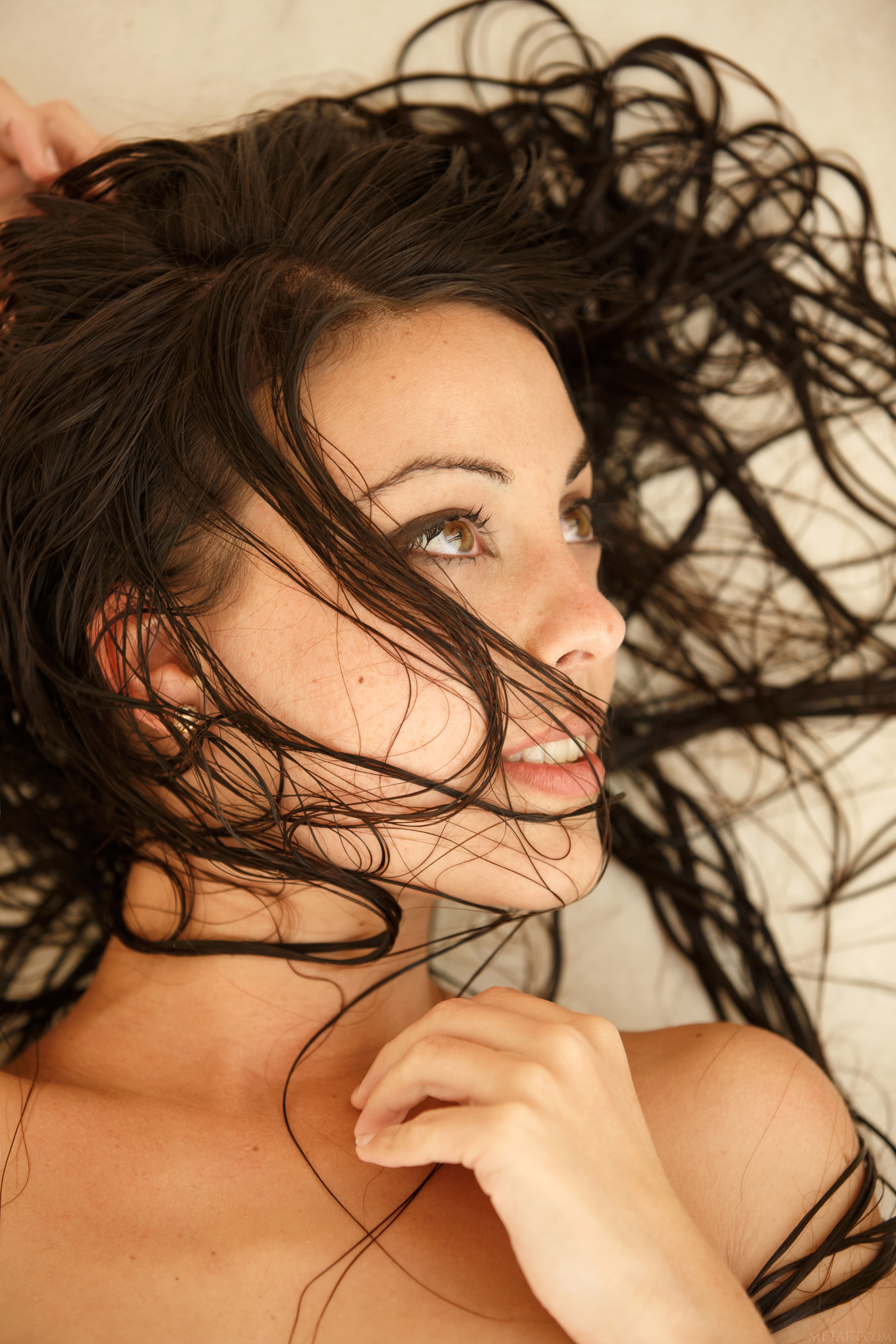 Woman with wet dark hair lying down HD Wallpaper
