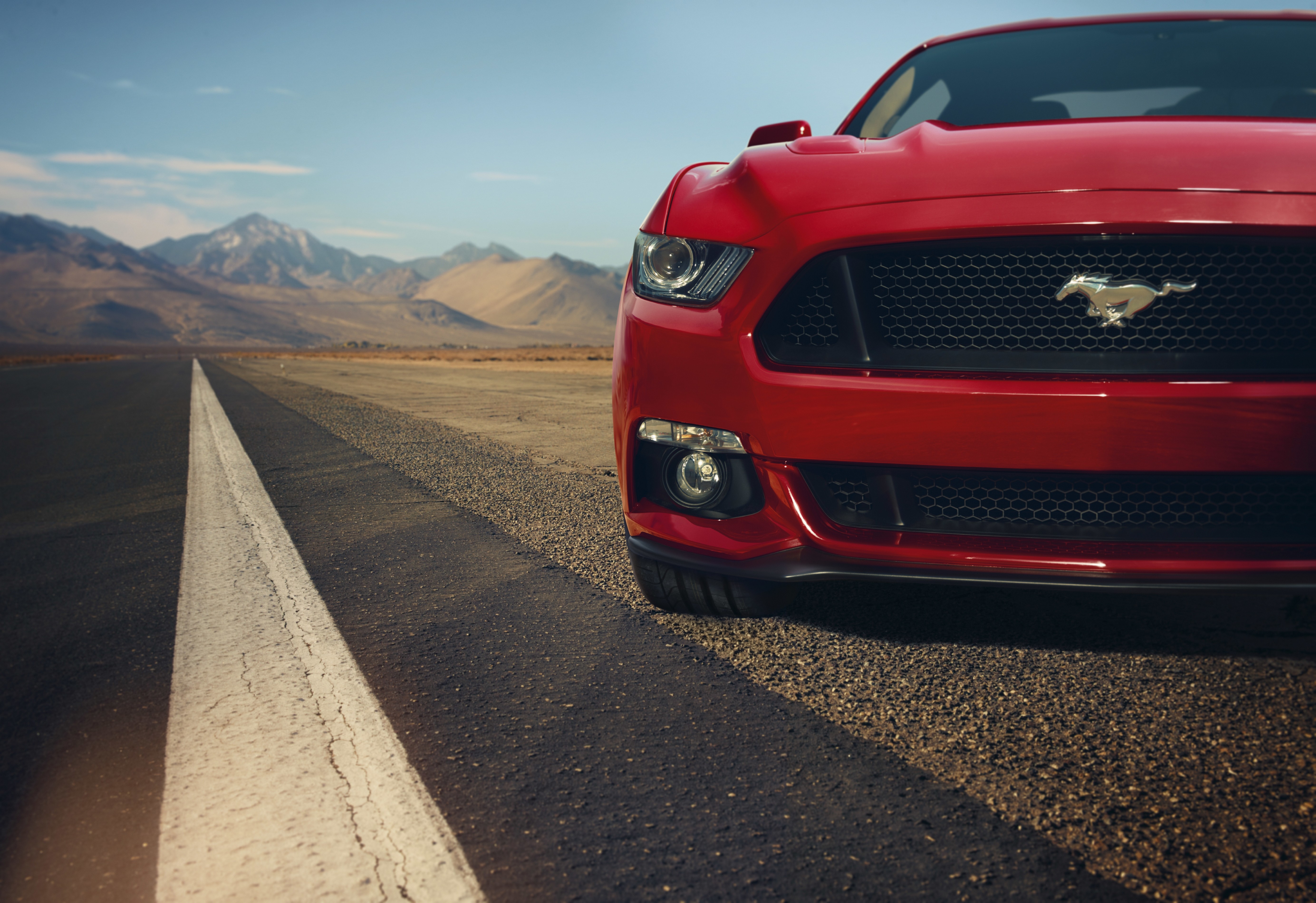 Red Ford Mustang on a Desert Road HD Wallpaper