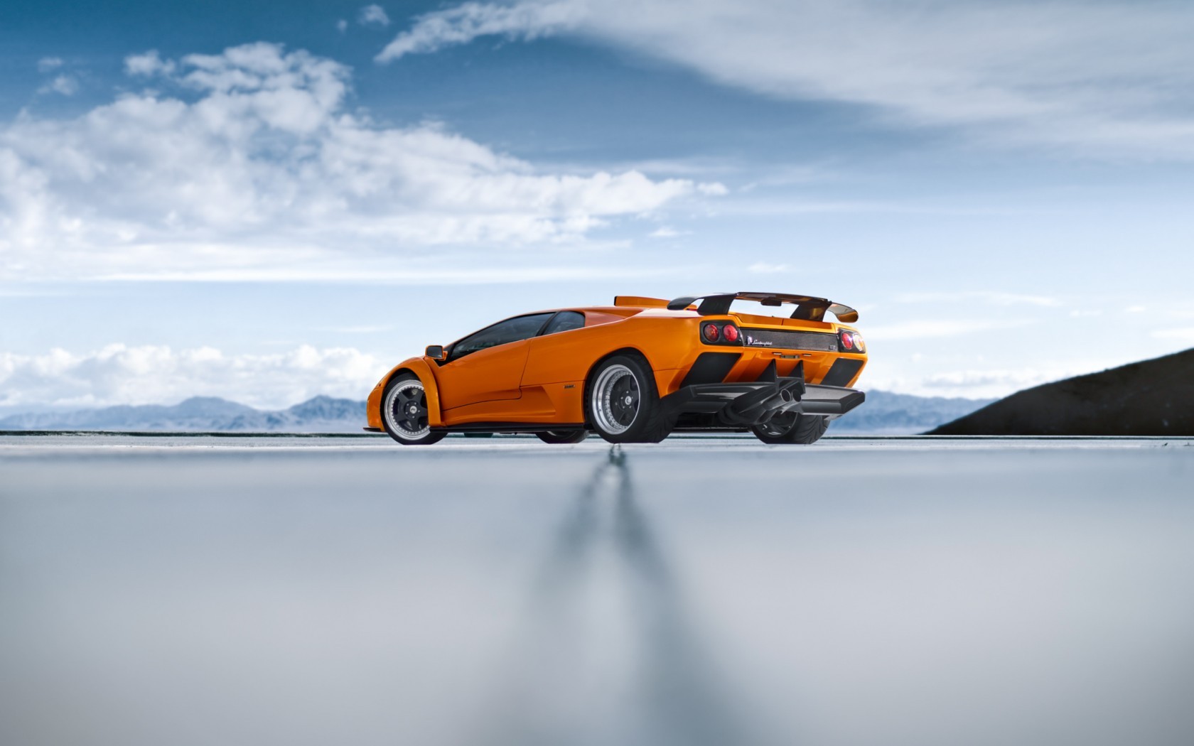 Orange Lamborghini Diablo on a reflective surface HD Wallpaper