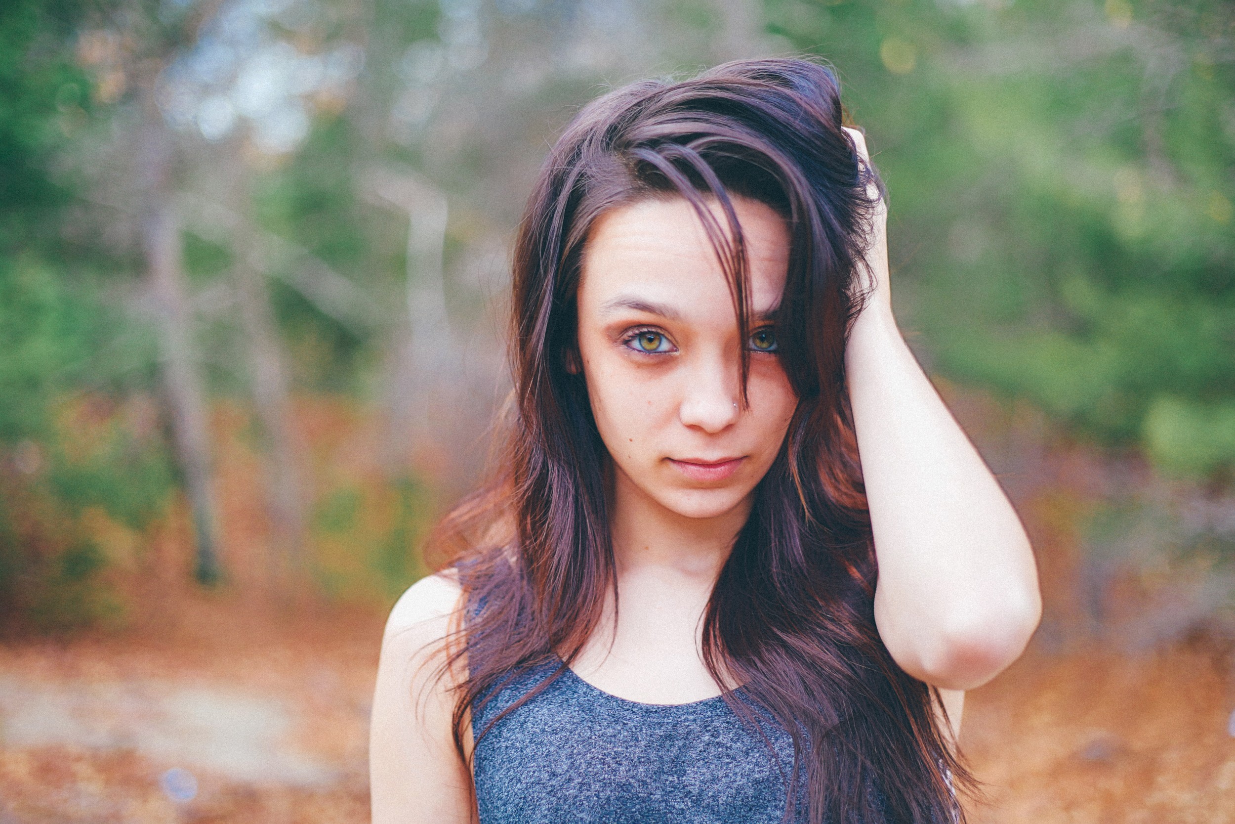 Woman with hand in hair outdoors HD Wallpaper