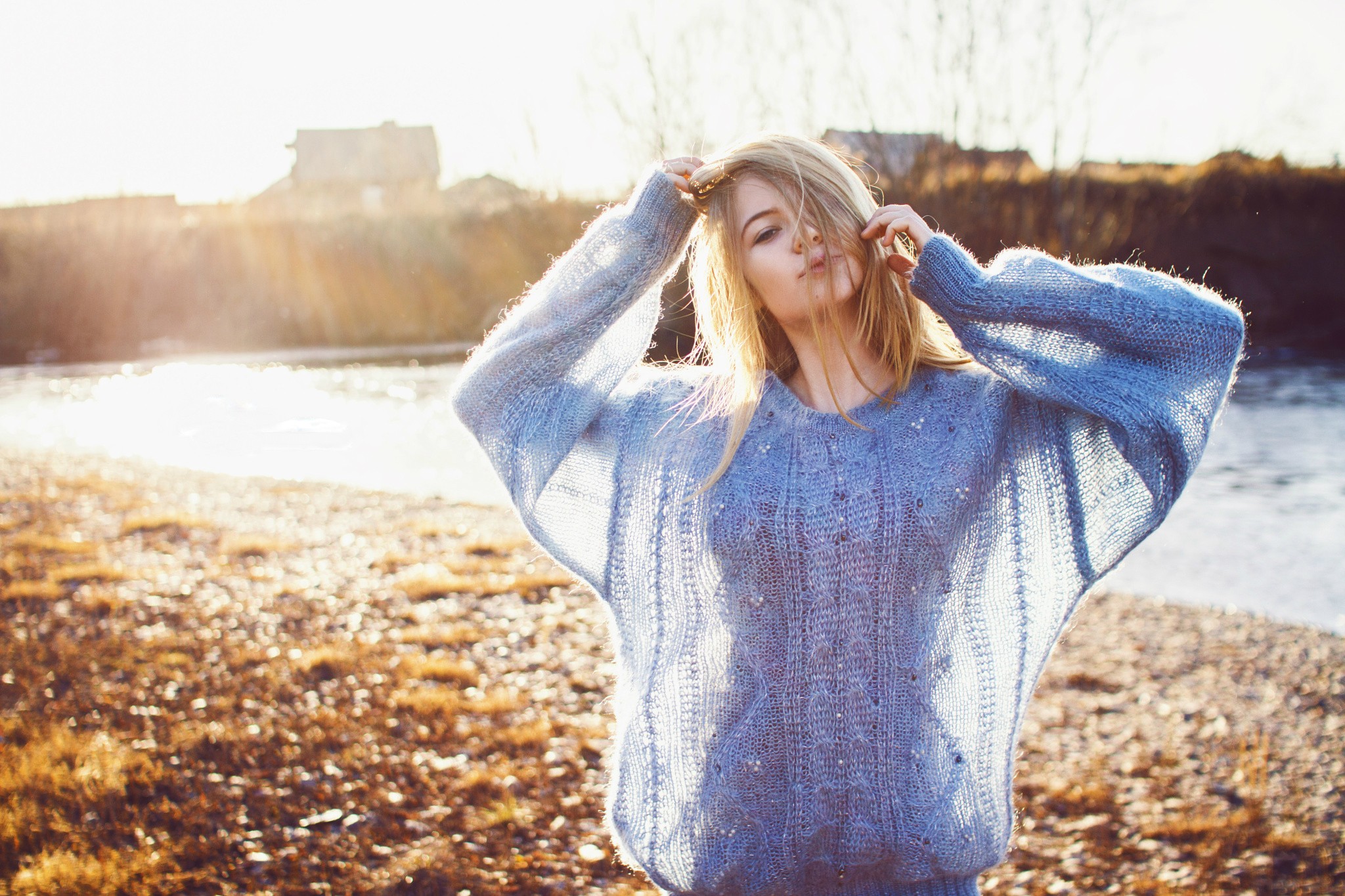 Woman in a blue sweater by the water HD Wallpaper