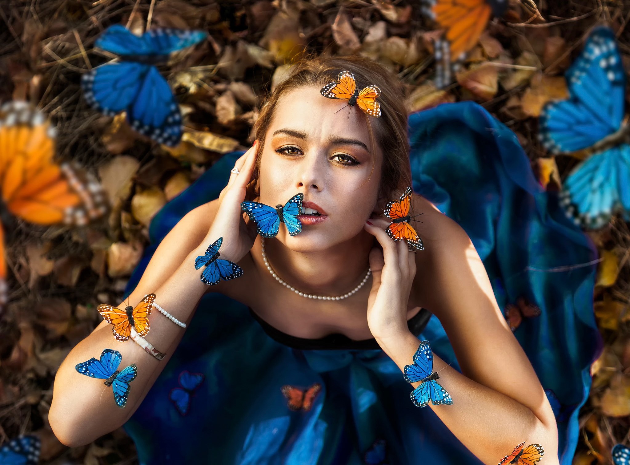 Woman with butterflies on her face and arms HD Wallpaper