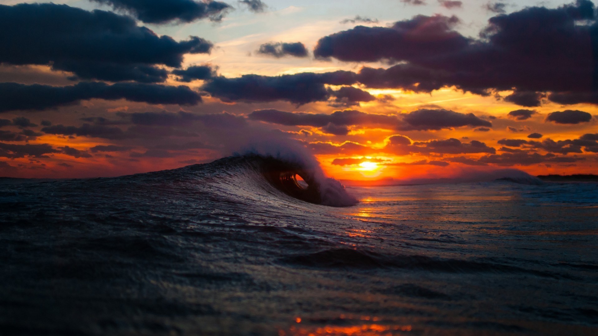Ocean wave at sunset with dramatic clouds HD Wallpaper