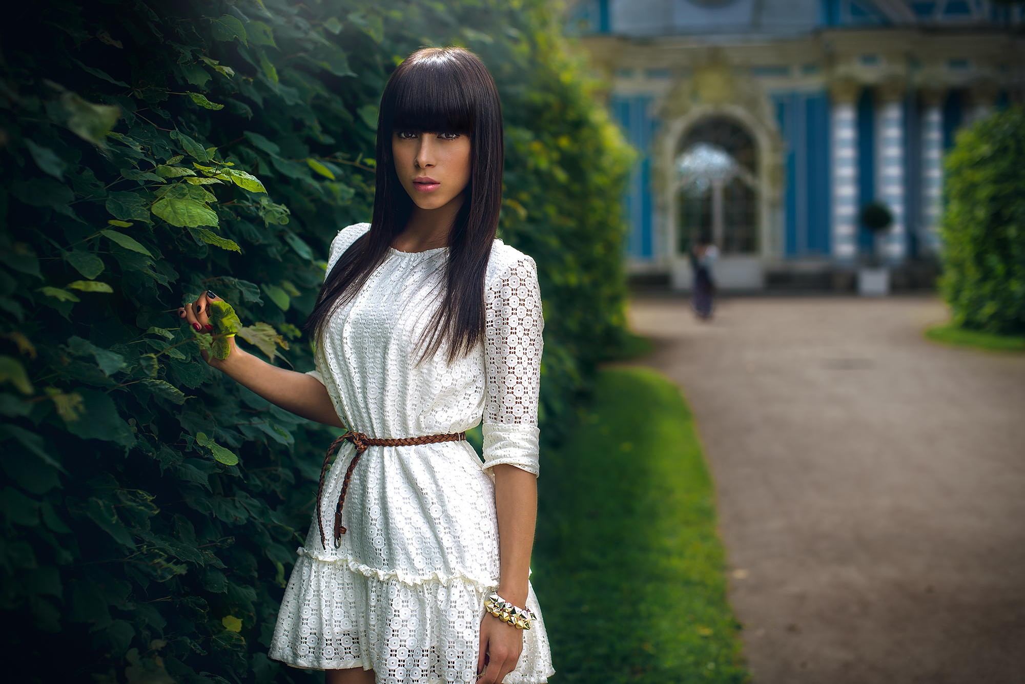 Woman in white dress with bangs in a garden HD Wallpaper