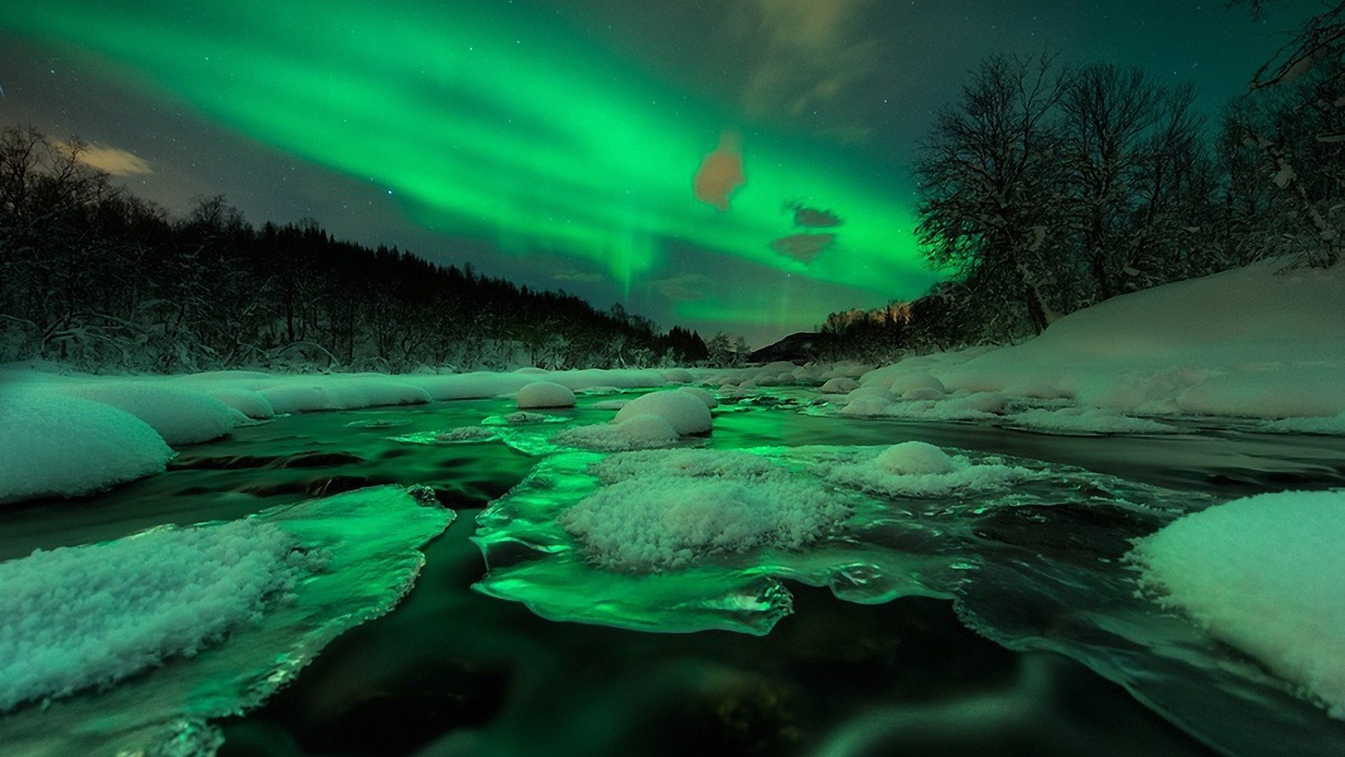 Aurora Borealis over a frozen river in winter HD Wallpaper