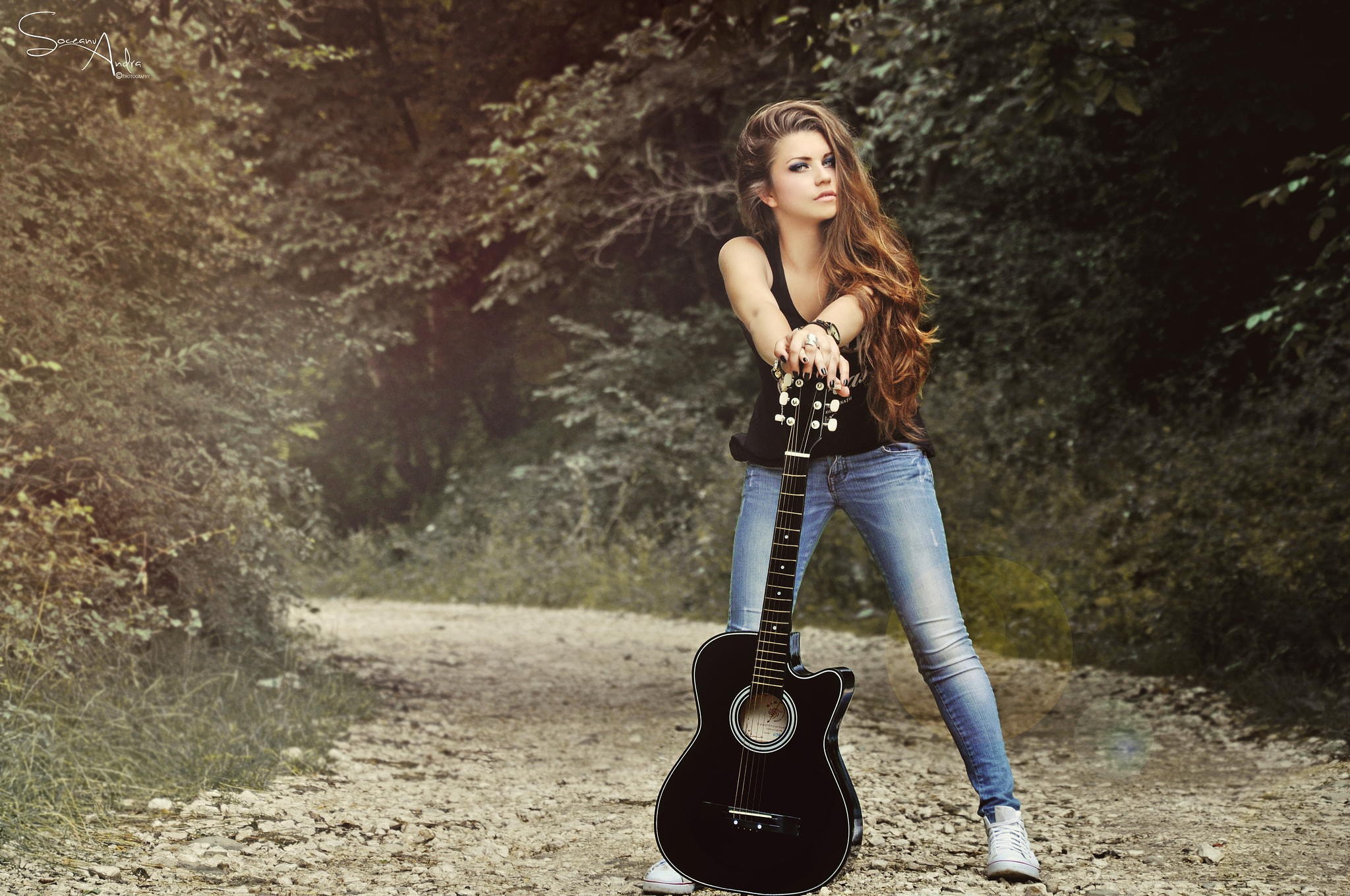 Woman with guitar on a dirt road HD Wallpaper