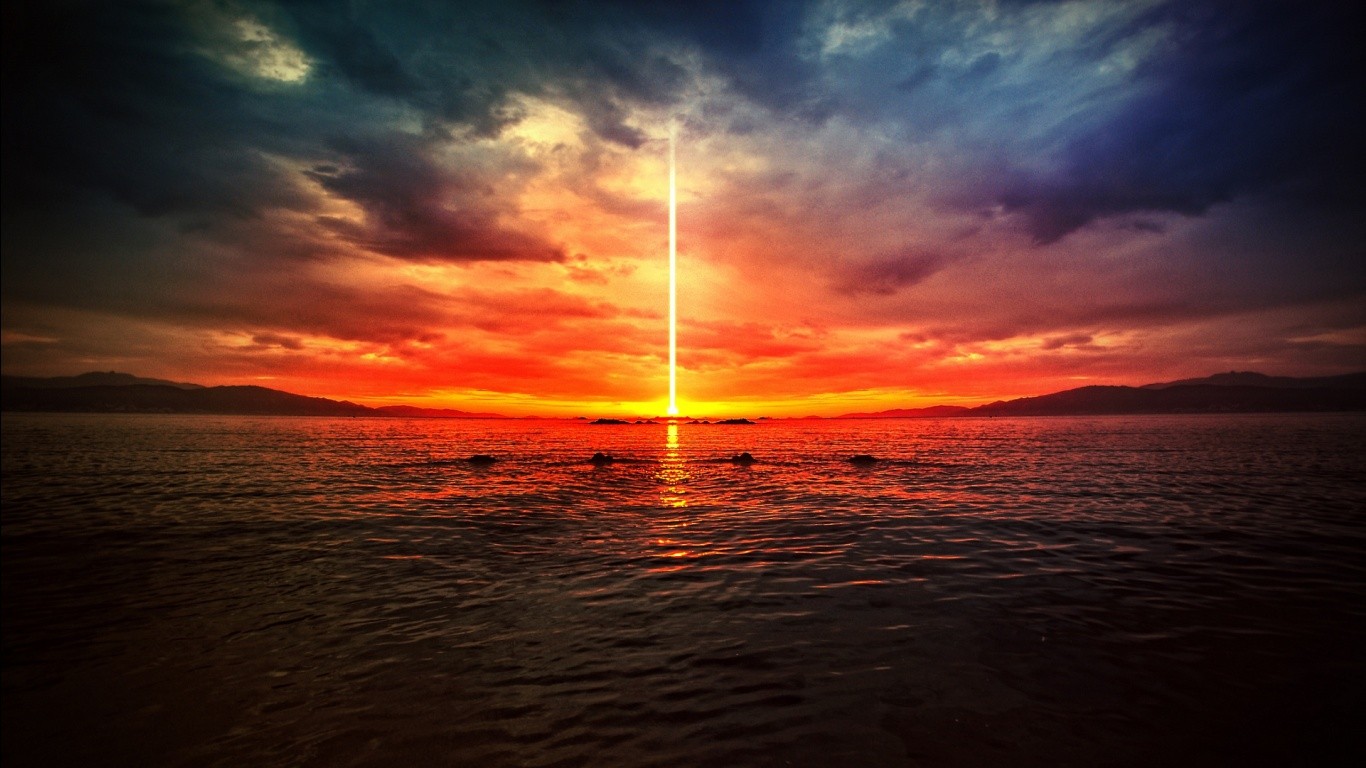 Dramatic sunset over the sea with a light beam HD Wallpaper