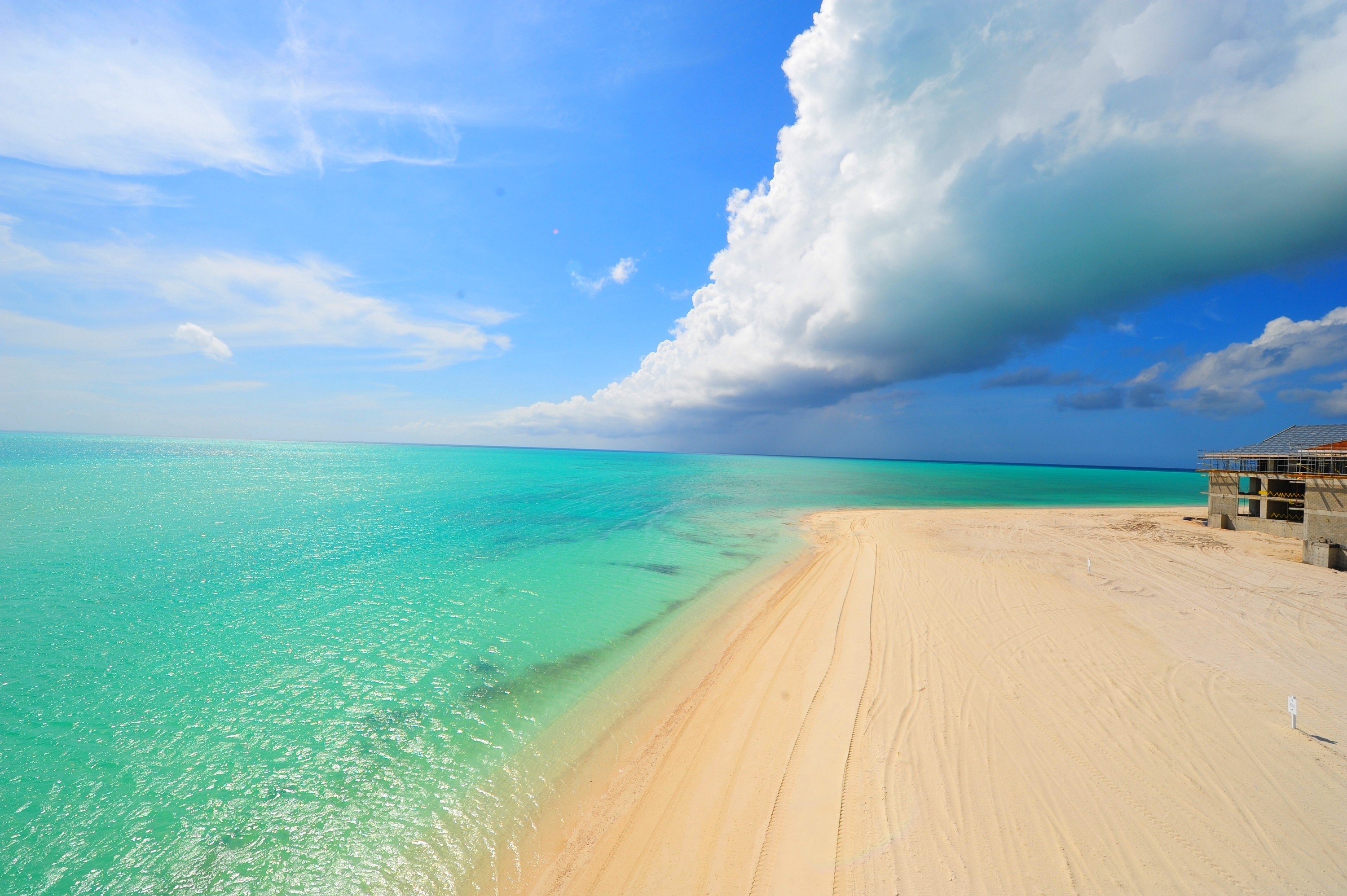 Turquoise Caribbean Sea and Sandy Beach with Clouds HD Wallpaper