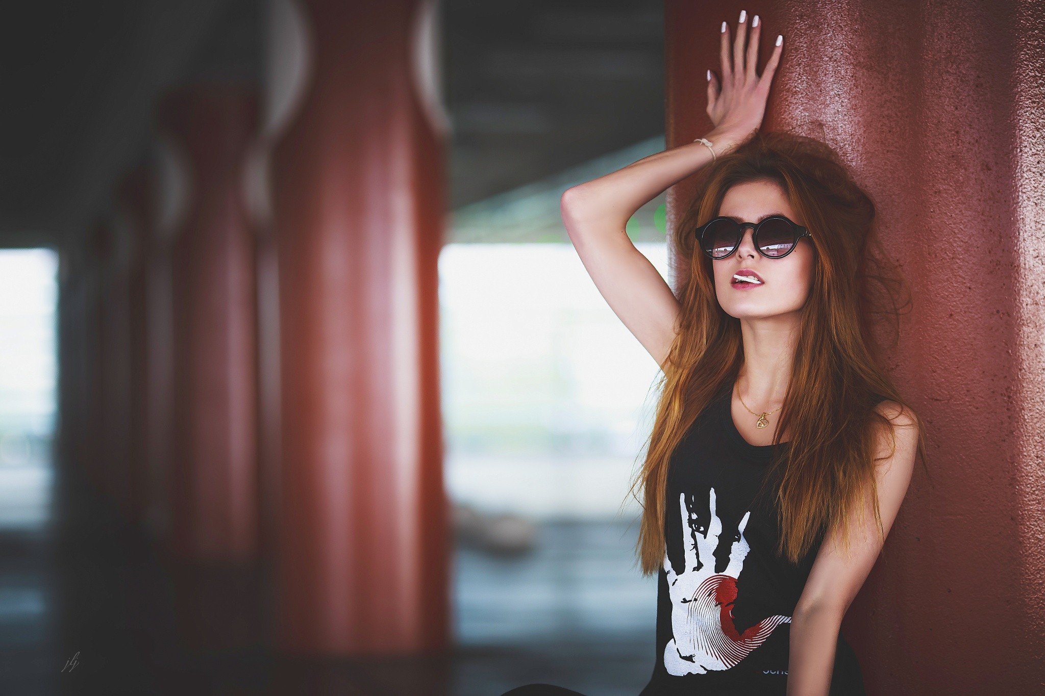 Redhead woman with lollipop and sunglasses leaning on pillar HD Wallpaper