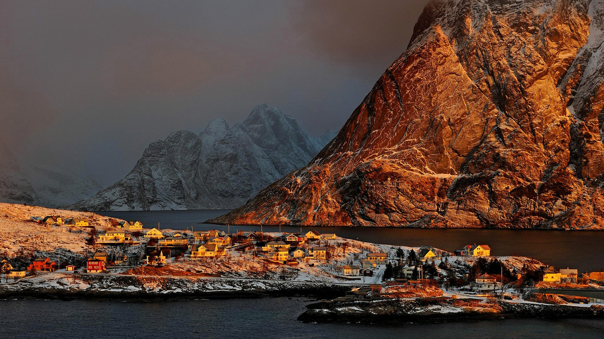 Winter village in Norway with mountains and sunlight HD Wallpaper
