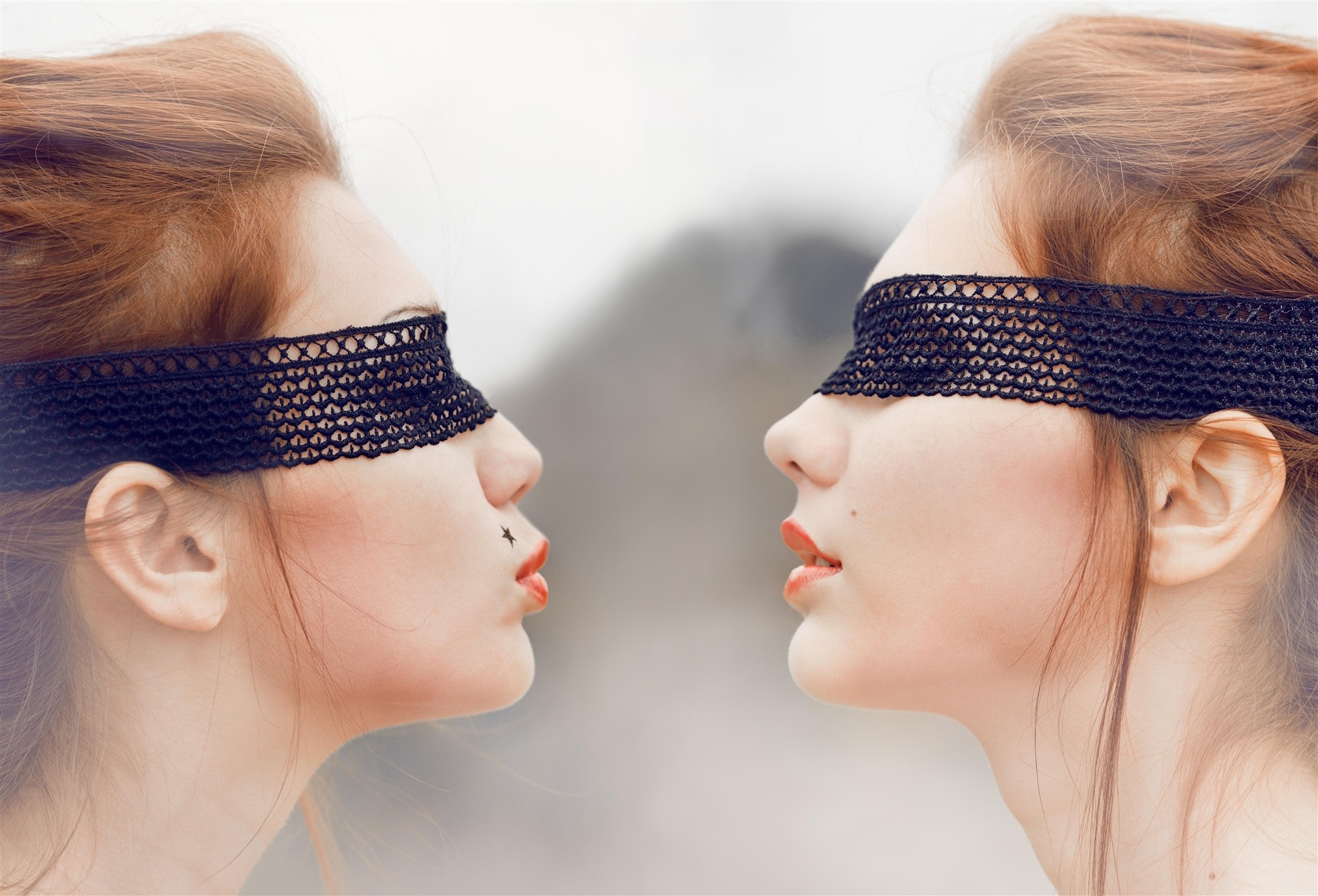 Two women with black blindfolds facing each other HD Wallpaper