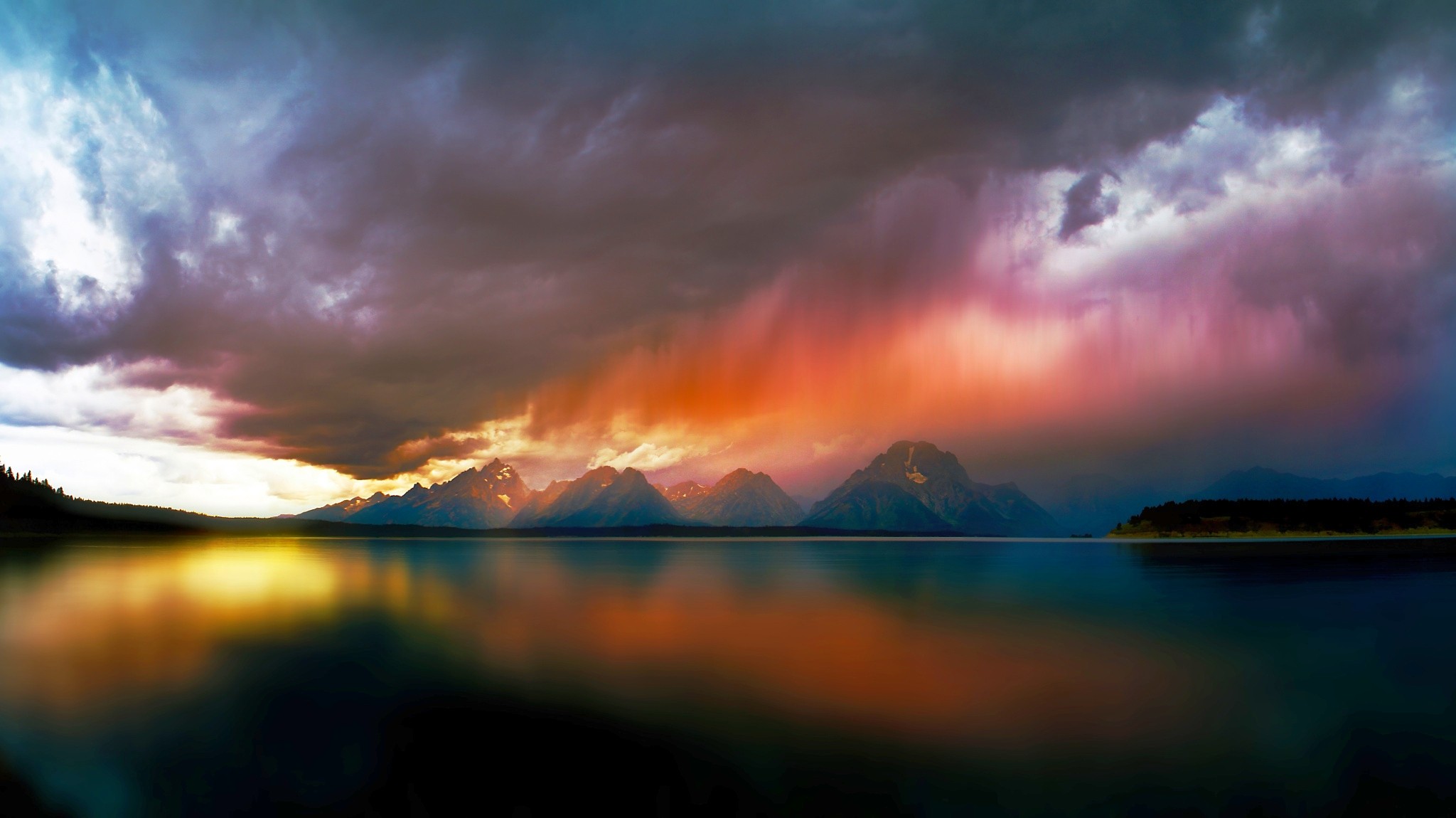 Stormy sunset over mountains reflected in a lake HD Wallpaper
