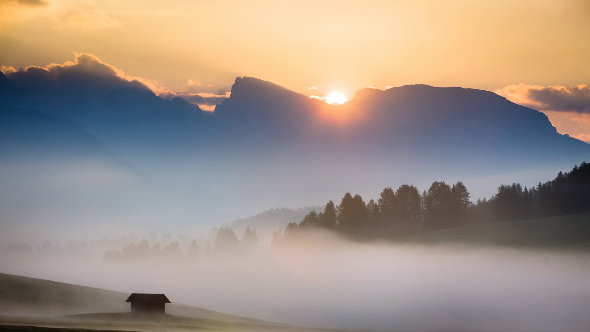 Misty mountain landscape at sunrise with a small house HD Wallpaper