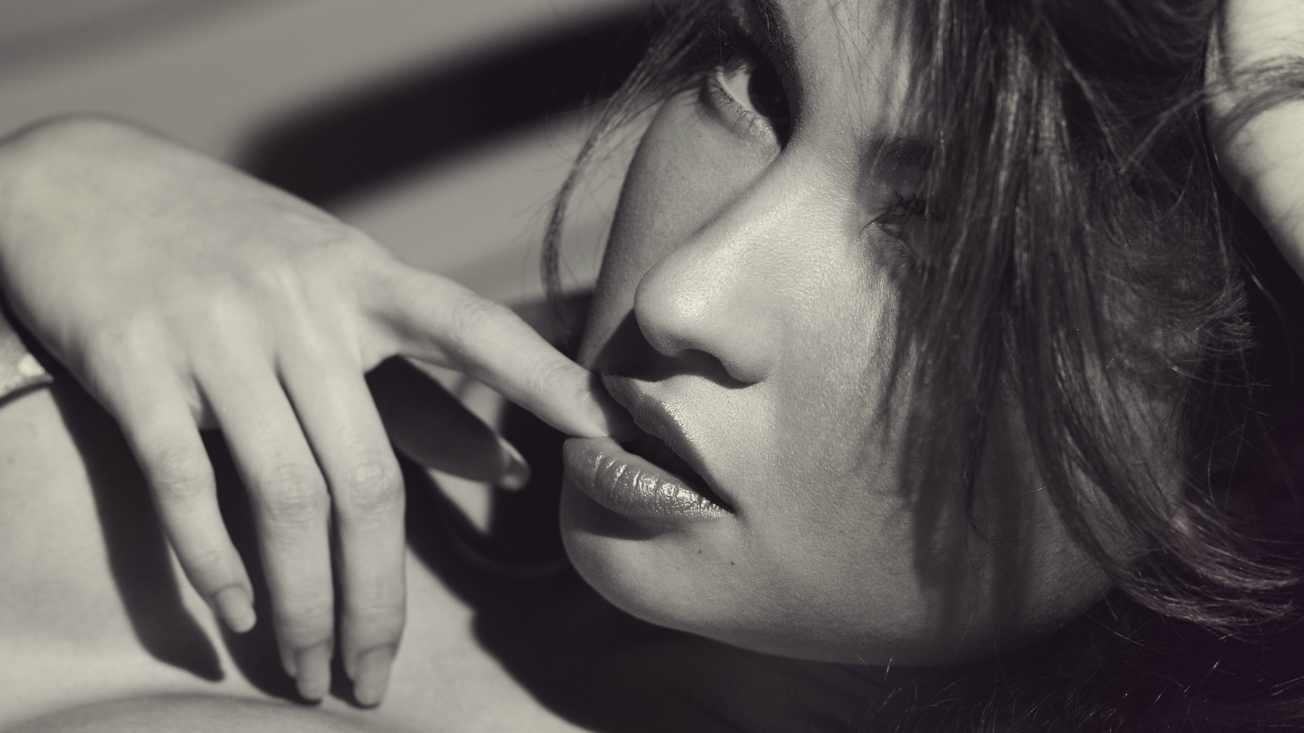 Monochrome close-up of a woman's face and hand HD Wallpaper