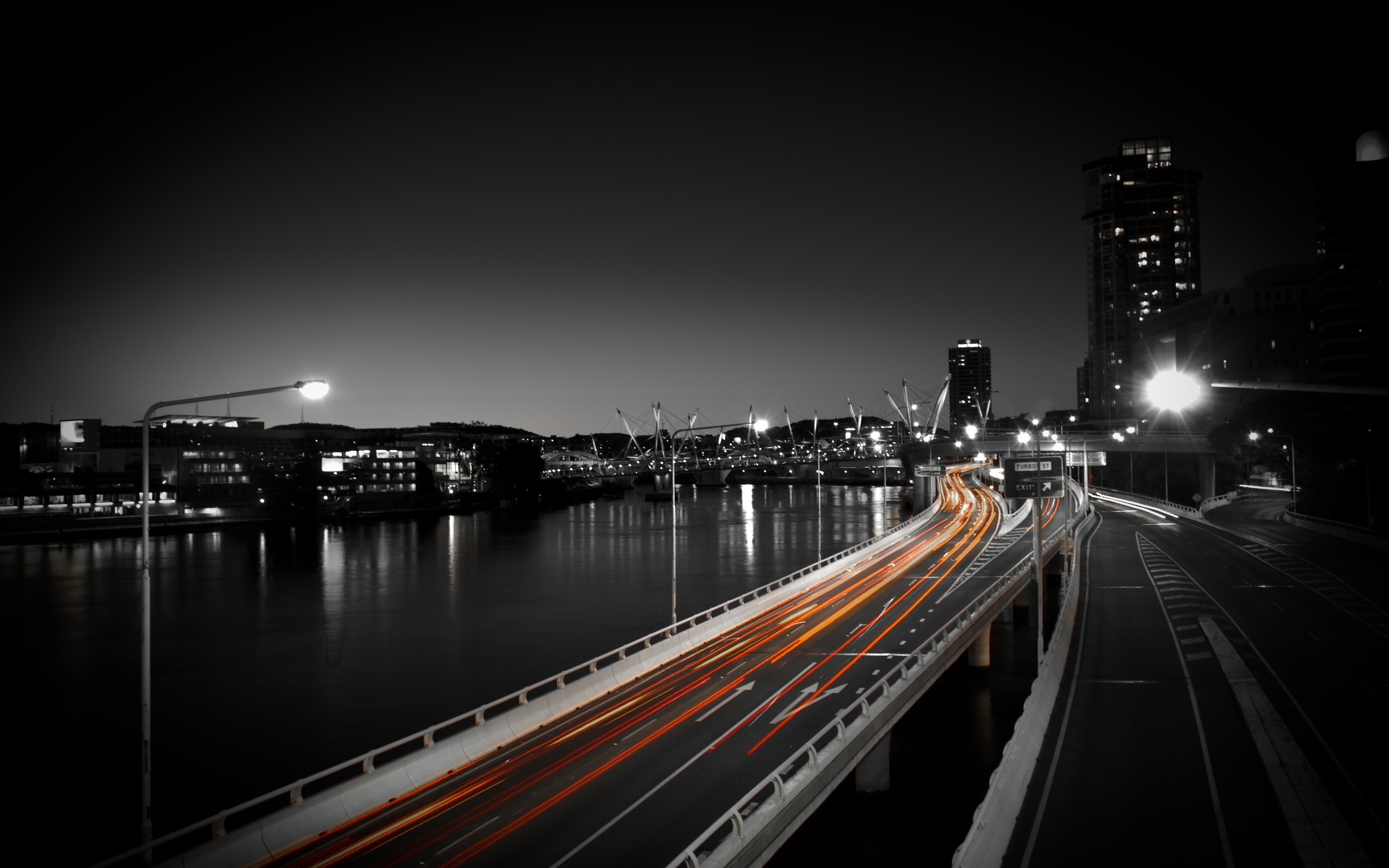 Cityscape with light trails on a bridge at night HD Wallpaper