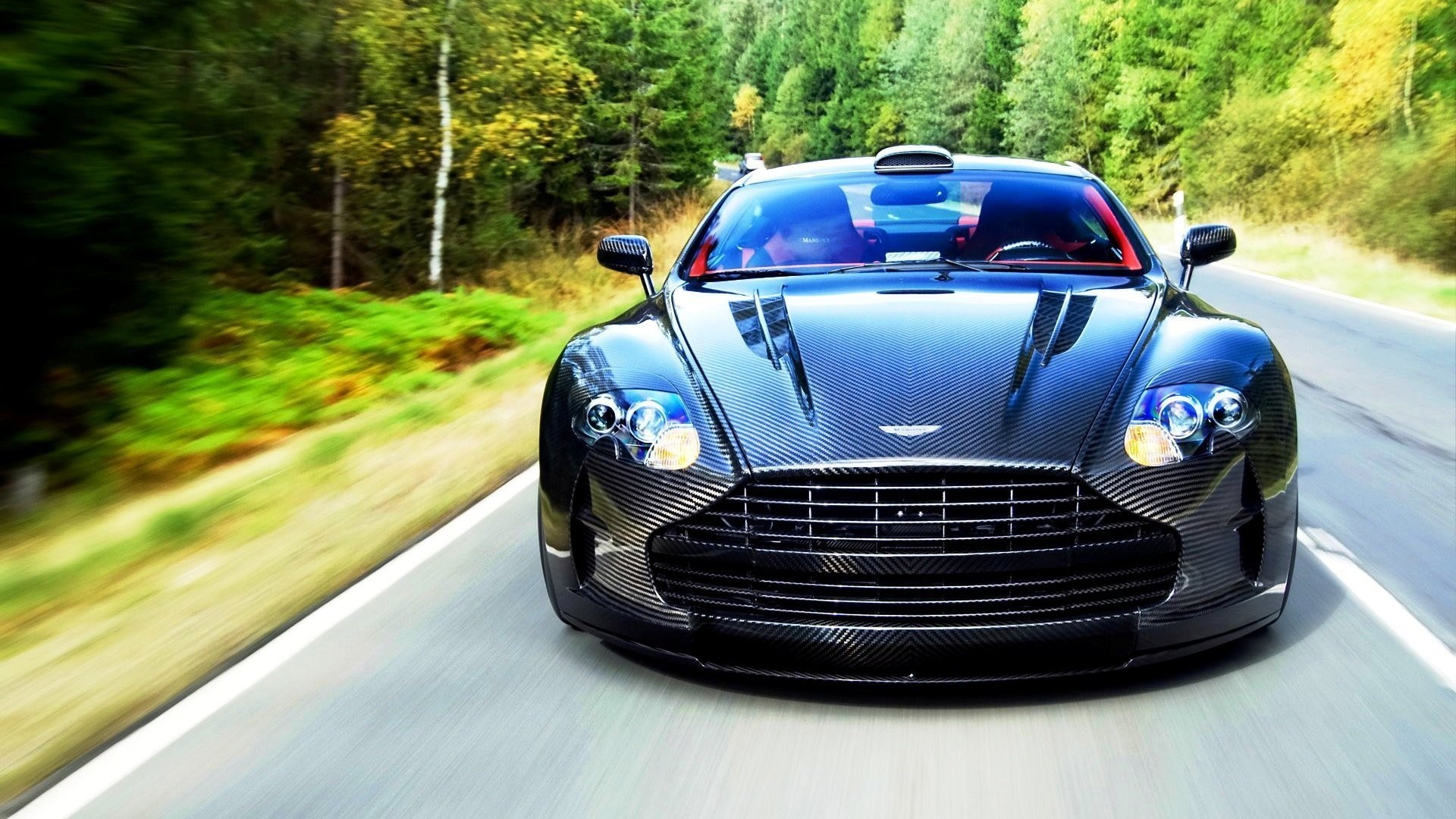 Aston Martin car driving on a forest road HD Wallpaper