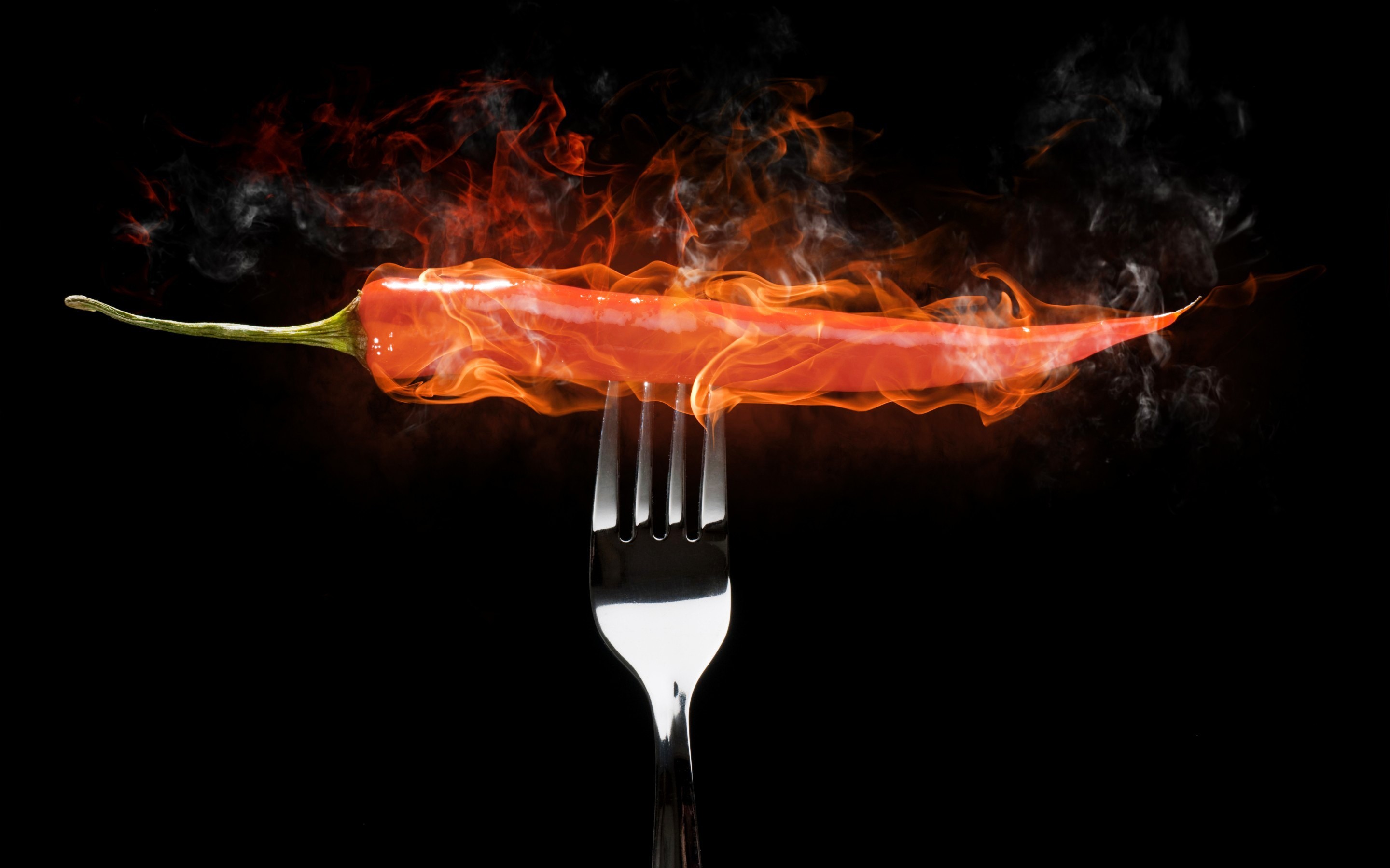 Red chili pepper on a fork engulfed in flames HD Wallpaper