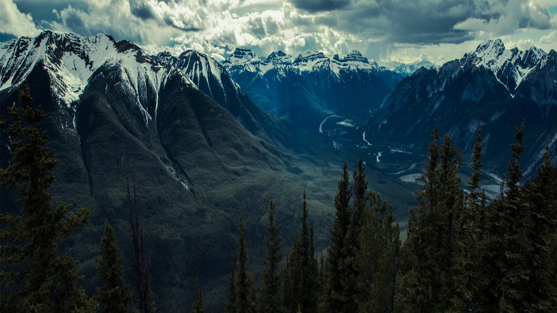 Snow-capped mountains and a valley with a river HD Wallpaper