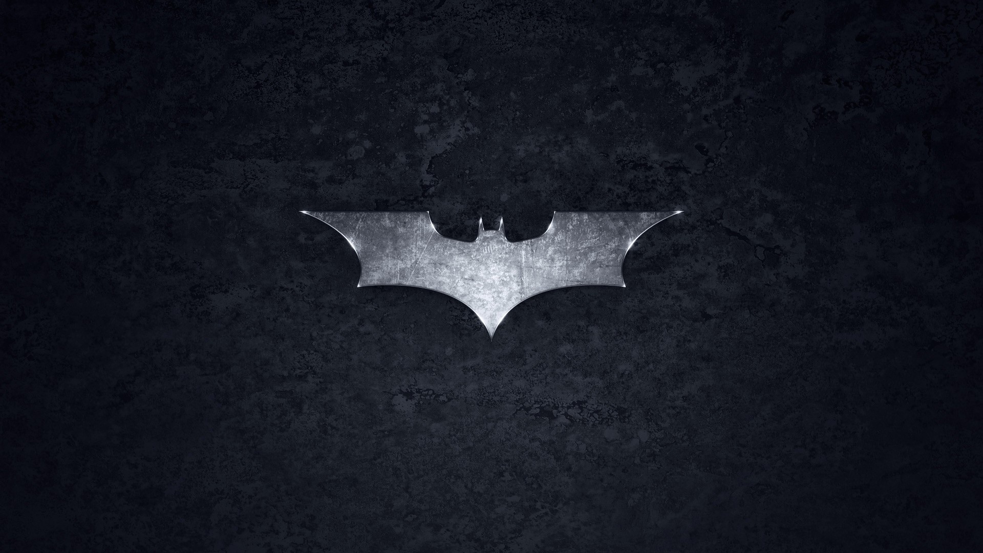 The Batman Logo on a Dark Textured Surface HD Wallpaper