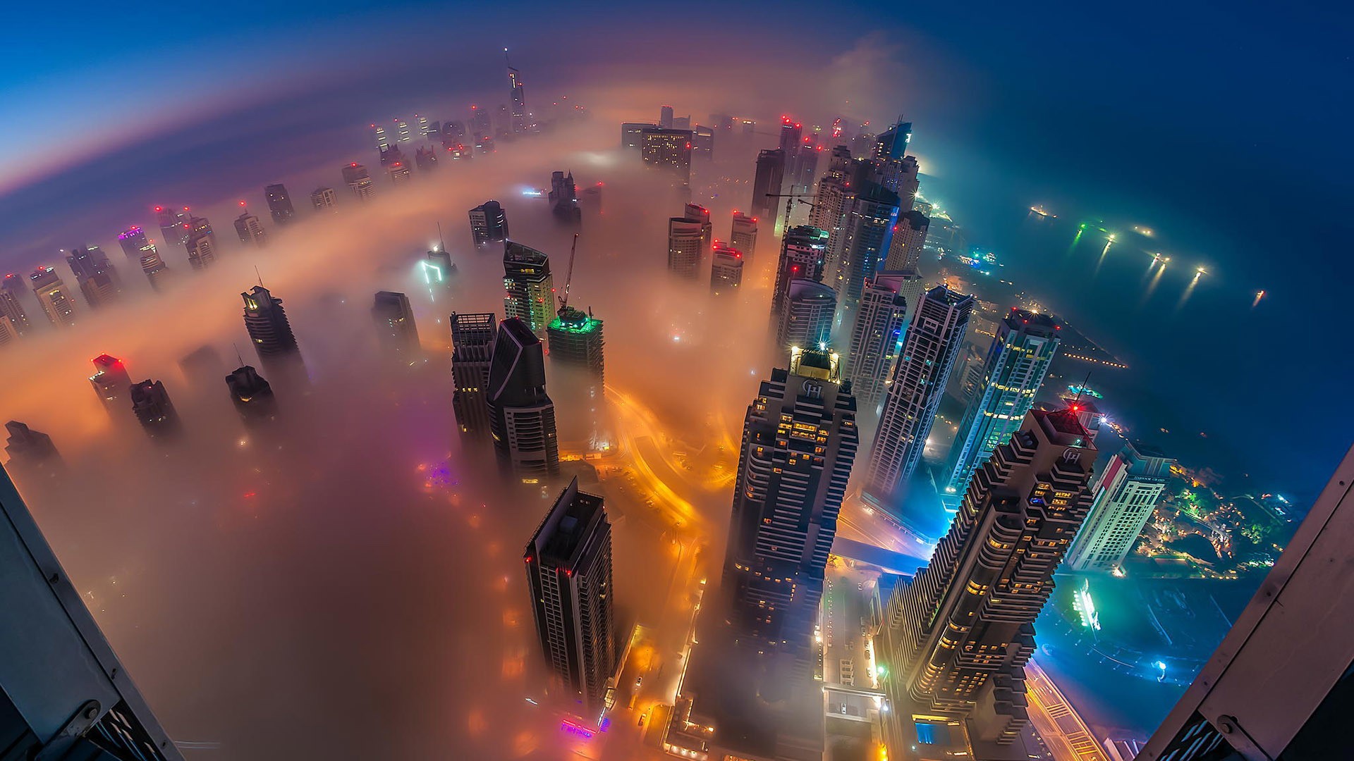 Dubai skyscrapers shrouded in mist at night HD Wallpaper