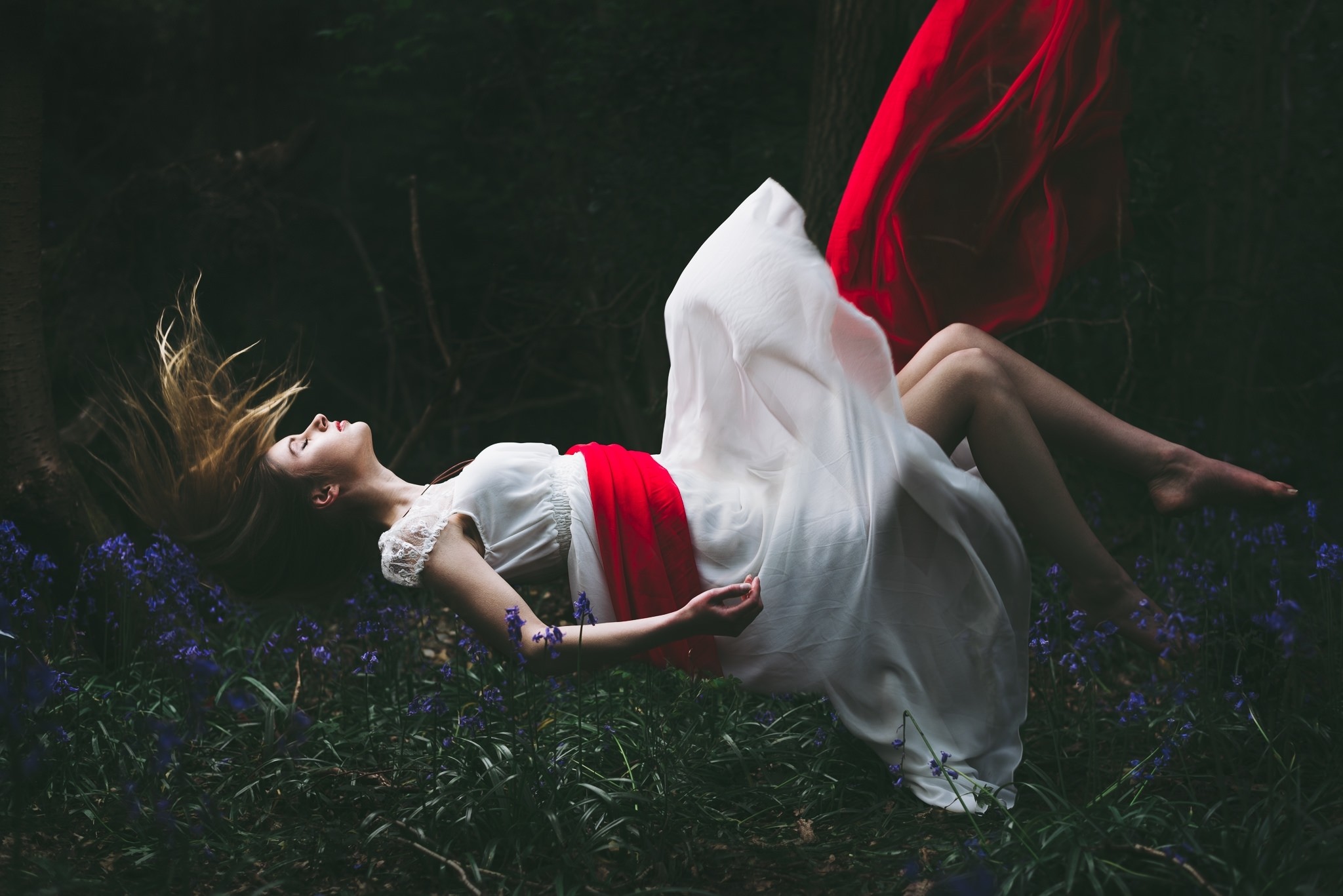 Woman in white dress floating in forest HD Wallpaper