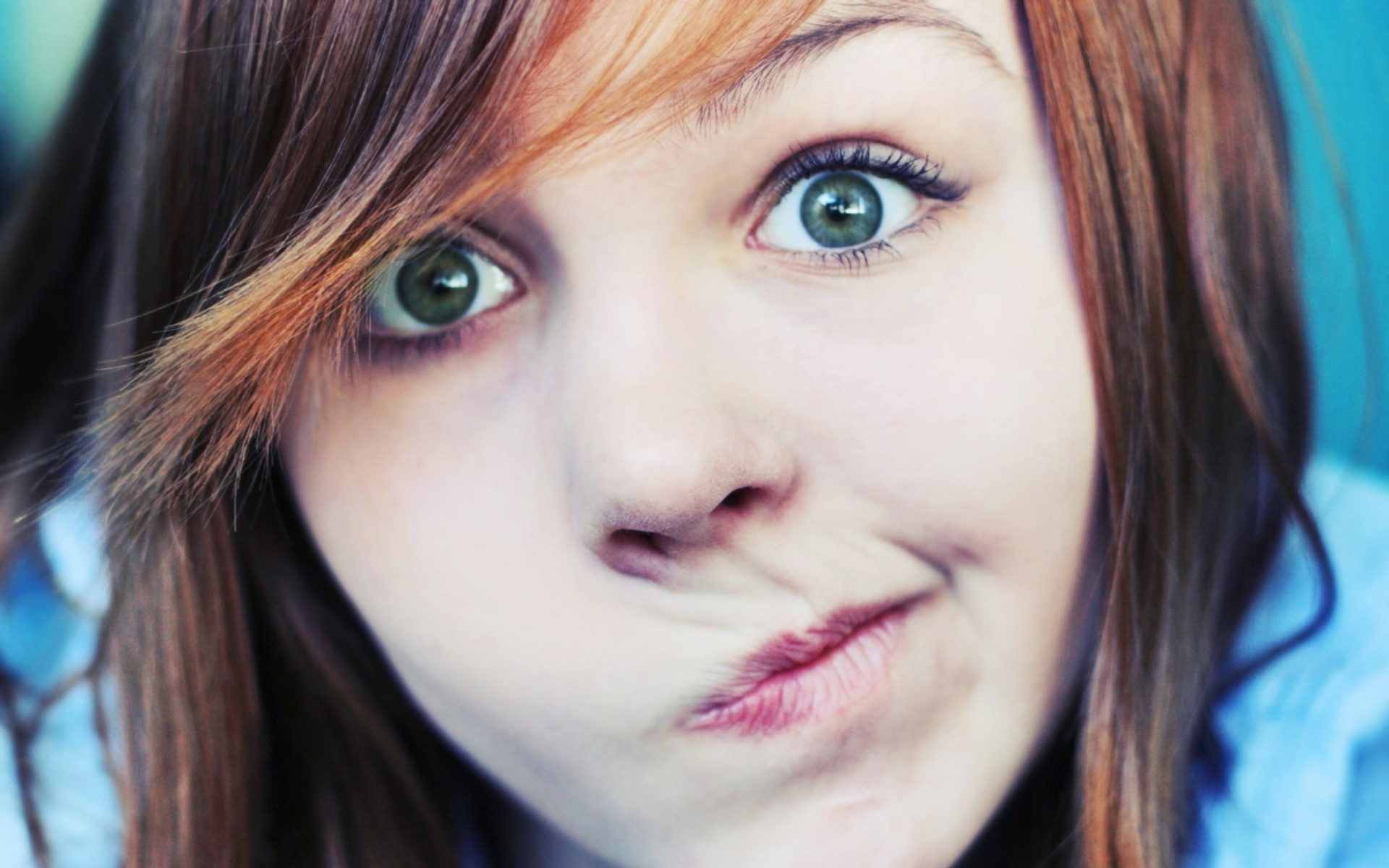 Girl with green eyes making a funny face HD Wallpaper