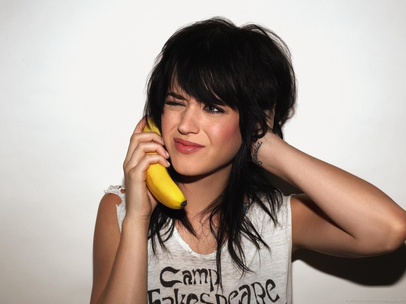 Katy Perry holding a banana to her ear HD Wallpaper