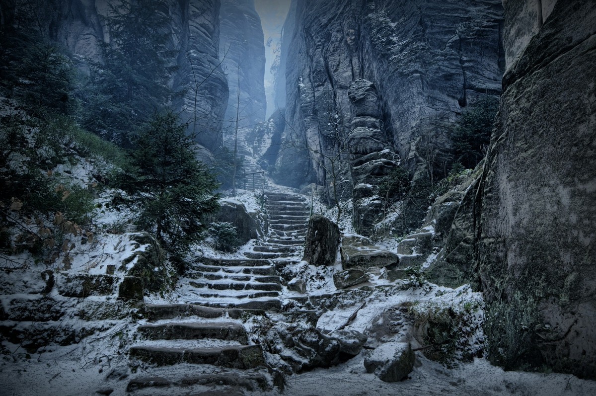 Stone stairs covered in snow in a rocky canyon HD Wallpaper