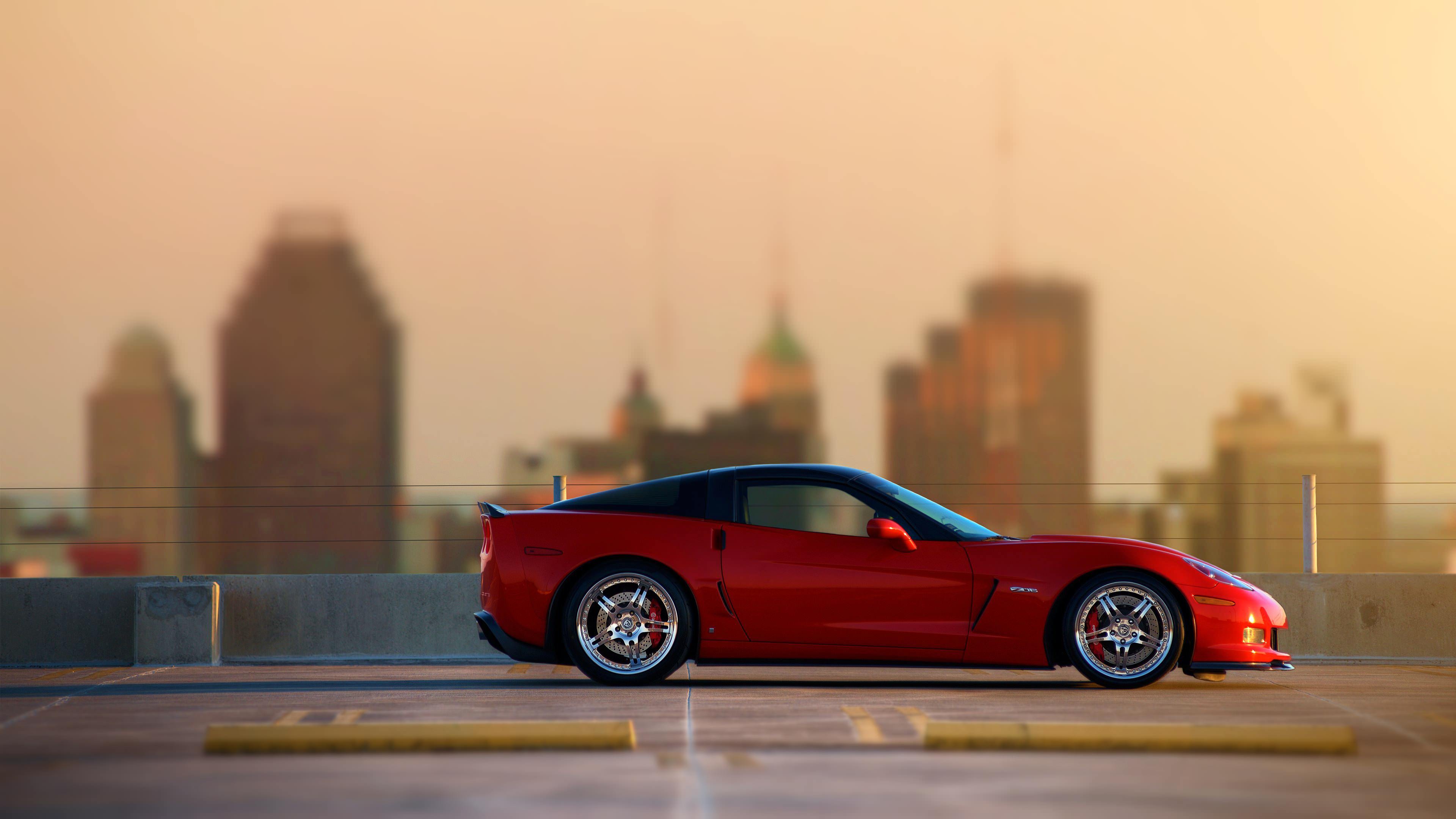 Red Chevrolet Corvette parked on a rooftop HD Wallpaper