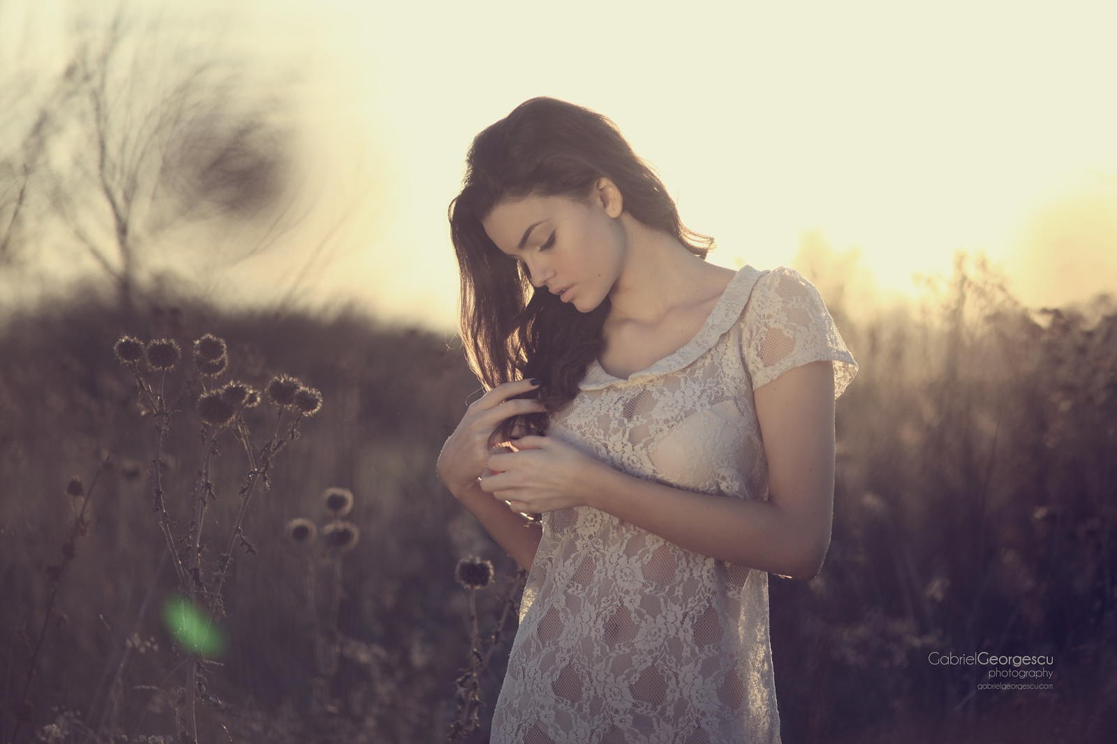 Woman in white lace dress in a field at sunset HD Wallpaper