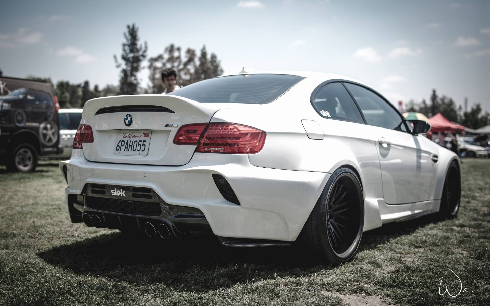 White BMW M3 with custom body kit on grass HD Wallpaper