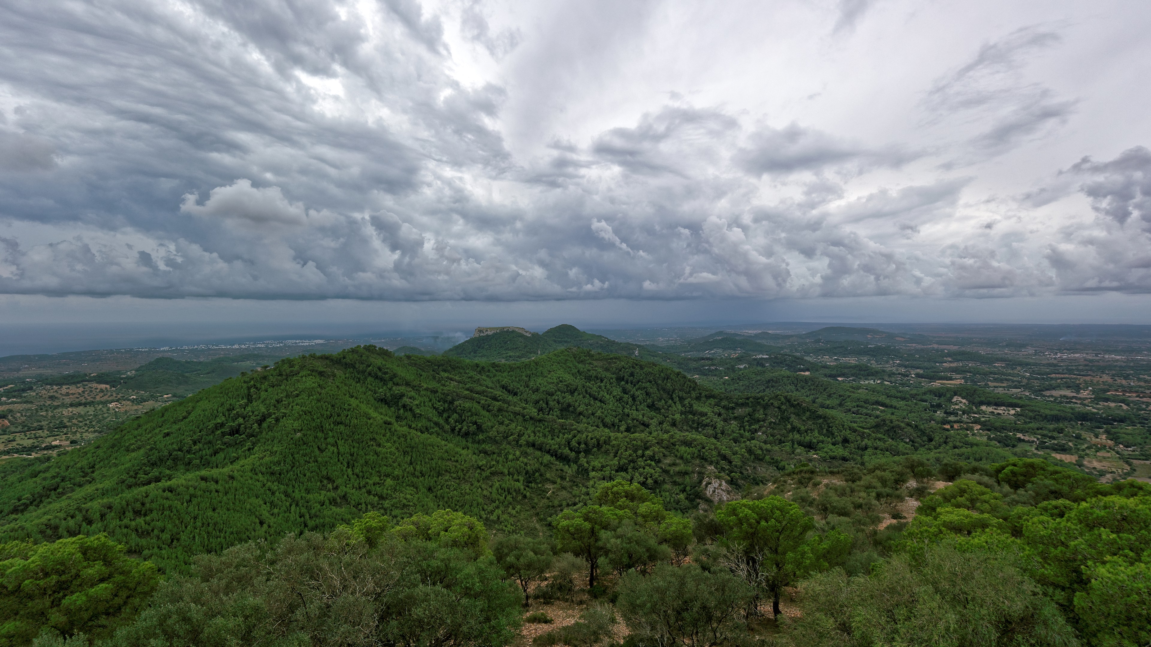 Mallorca landscape with green hills and stormy clouds HD Wallpaper